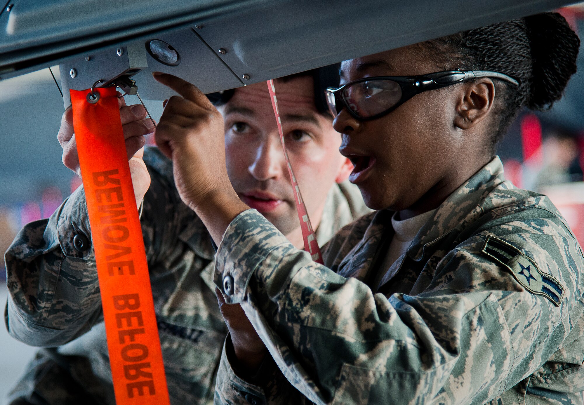 Airman 1st Class Quionjay Jackson and Senior Airman Thomas Schultz, of the 96th Aircraft Maintenance Squadron Blue, discuss the next procedure to accomplish on their F-16 Fighting Falcon during the annual weapons load crew of the year competition Feb. 14 at Eglin Air Force Base, Fla.  Teams from AMU Blue battled AMU Red in loading a GBU, AIM-9 and an AIM-120 on their respective aircraft.  The winners will be announced at the 96th Maintenance Group banquet.  (U.S. Air Force photo/Samuel King Jr.)