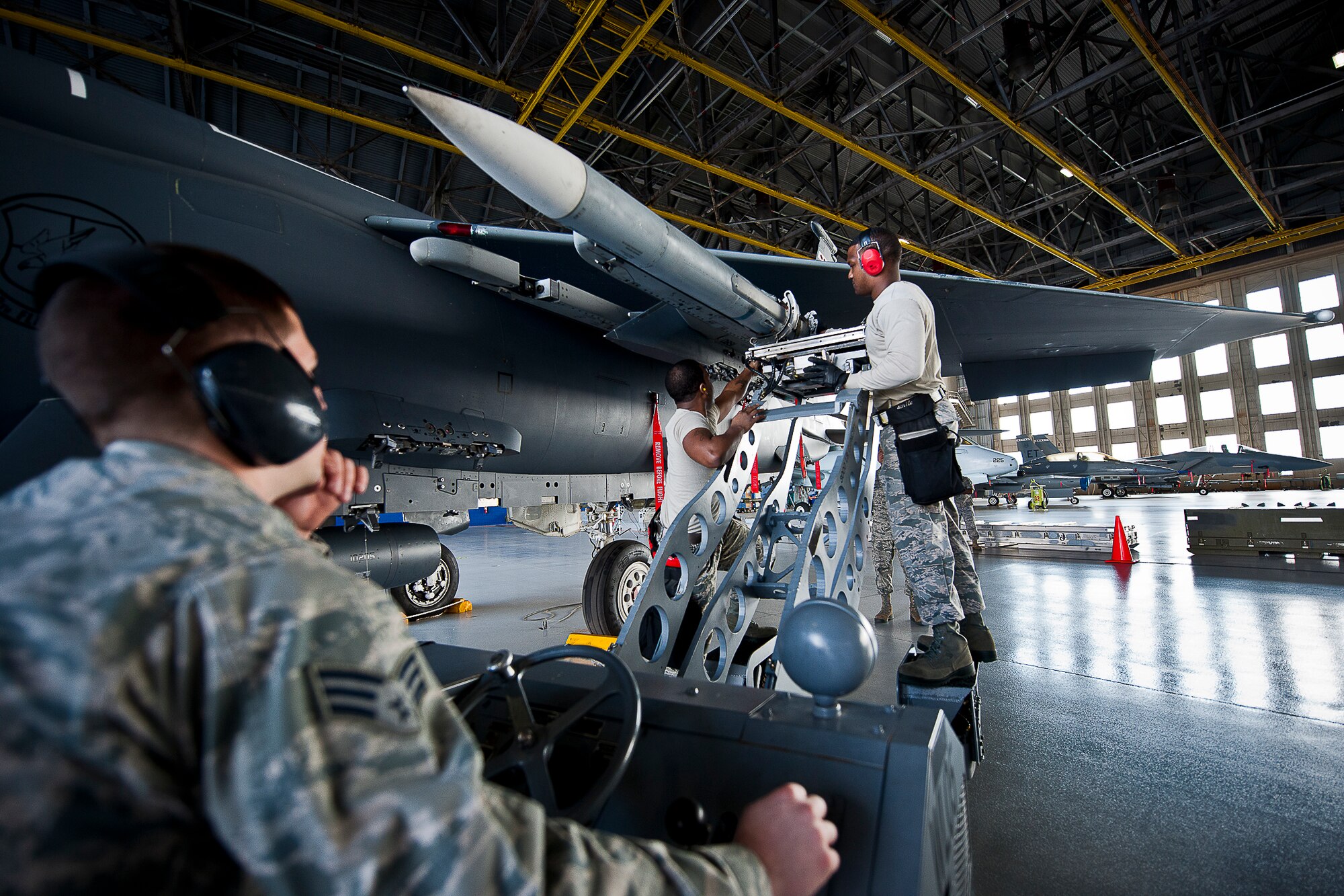 96th Aircraft Maintenance Squadron Red team members connect an AIM-120 to an F-15 Eagle during the first quarter weapons load crew competition Feb. 14 at Eglin Air Force Base, Fla.  Teams from AMU Blue battled AMU Red in loading a GBU, AIM-9 and an AIM-120 on their respective aircraft.  The winners will be announced at the 96th Maintenance Group banquet.  (U.S. Air Force photo/Samuel King Jr.)
