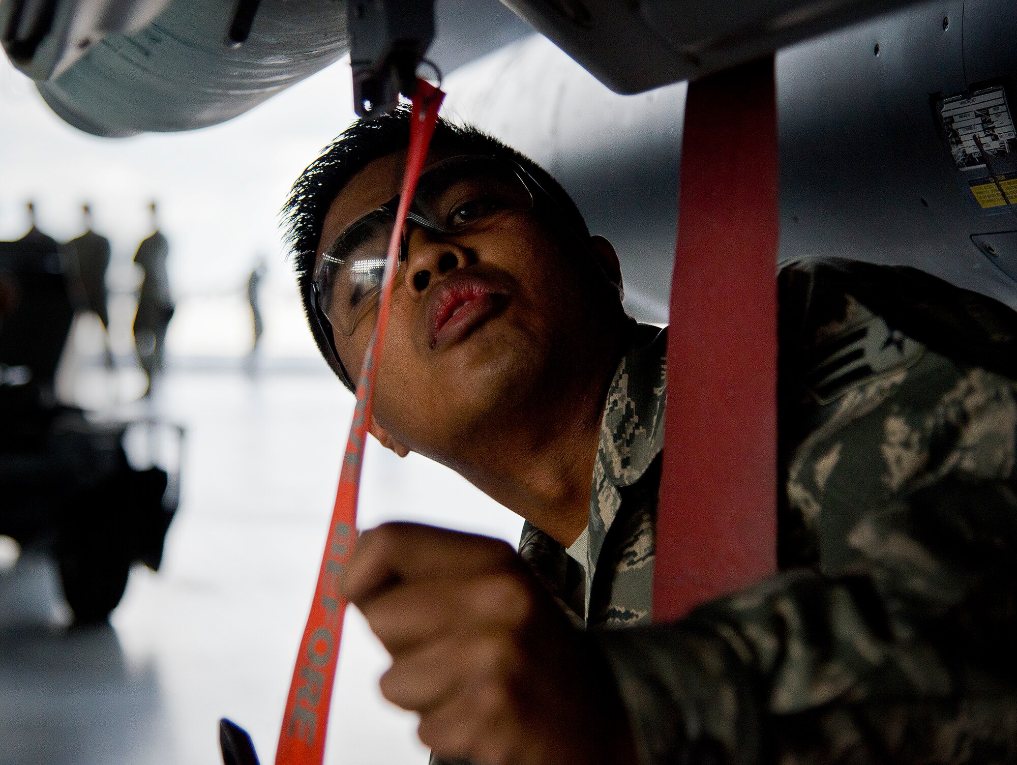 Senior Airman Marqwilliam Aguilar, of the 96th Aircraft Maintenance Squadron Red, checks the load of a Guided Bomb Unit-12 on his F-15 Eagle during the annual weapons load crew of the year competition Feb. 14 at Eglin Air Force Base, Fla.  Teams from AMU Blue battled AMU Red in loading a GBU, AIM-9 and an AIM-120 on their respective aircraft.  The winners will be announced at the 96th Maintenance Group banquet.  (U.S. Air Force photo/Samuel King Jr.)