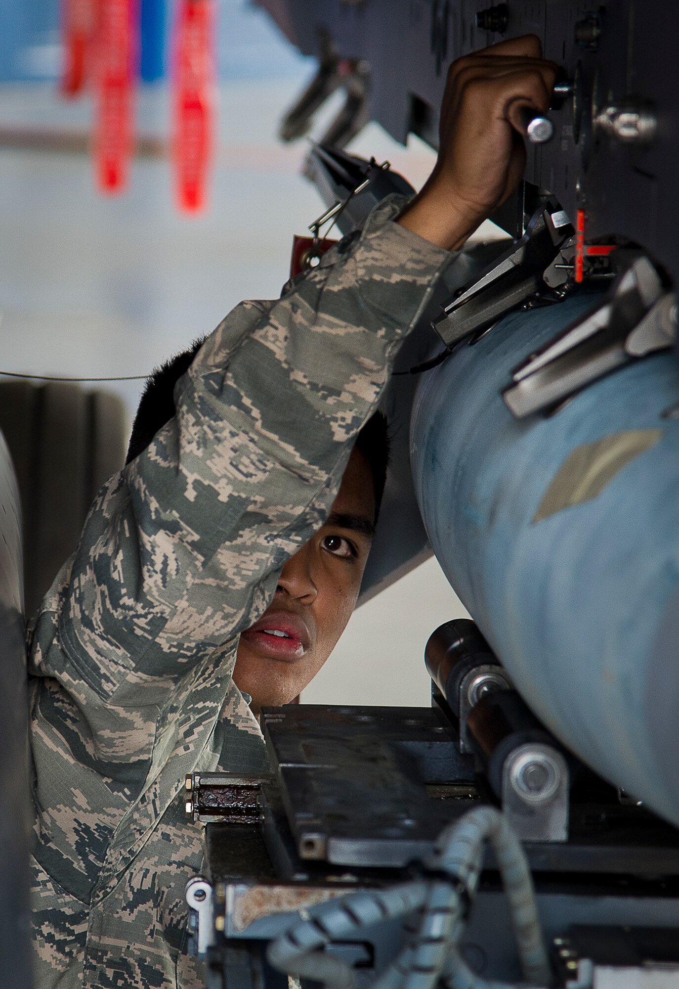 Senior Airman Marqwilliam Aguilar, of the 96th Aircraft Maintenance Squadron Red, tightens down a Guided Bomb Unit-12 to his F-15 Eagle during the annual weapons load crew of the year competition Feb. 14 at Eglin Air Force Base, Fla.  Teams from AMU Blue battled AMU Red in loading a GBU, AIM-9 and an AIM-120 on their respective aircraft.  The winners will be announced at the 96th Maintenance Group banquet.  (U.S. Air Force photo/Samuel King Jr.)