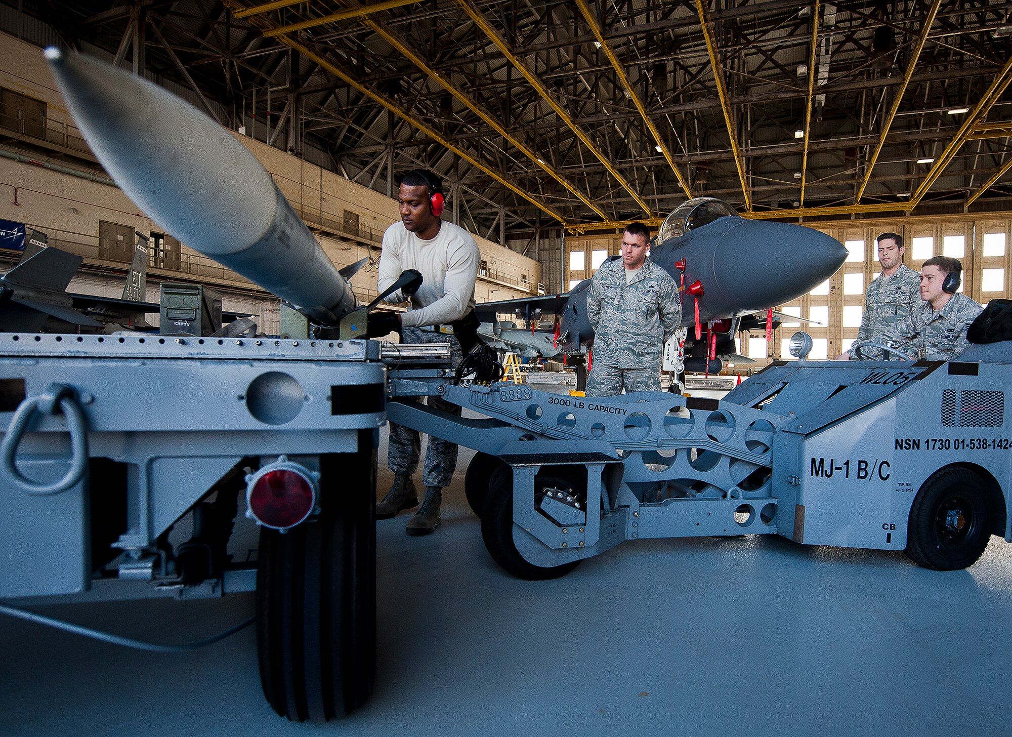 Staff Sgt. Timothy White, of the 96th Aircraft Maintenance Squadron Red, prepares an AIM-120 to be moved to an F-15 Eagle during the annual weapons load crew of the year competition Feb. 14 at Eglin Air Force Base, Fla.  Teams from AMU Blue battled AMU Red in loading a GBU, AIM-9 and an AIM-120 on their respective aircraft.  The winners will be announced at the 96th Maintenance Group banquet.  (U.S. Air Force photo/Samuel King Jr.)