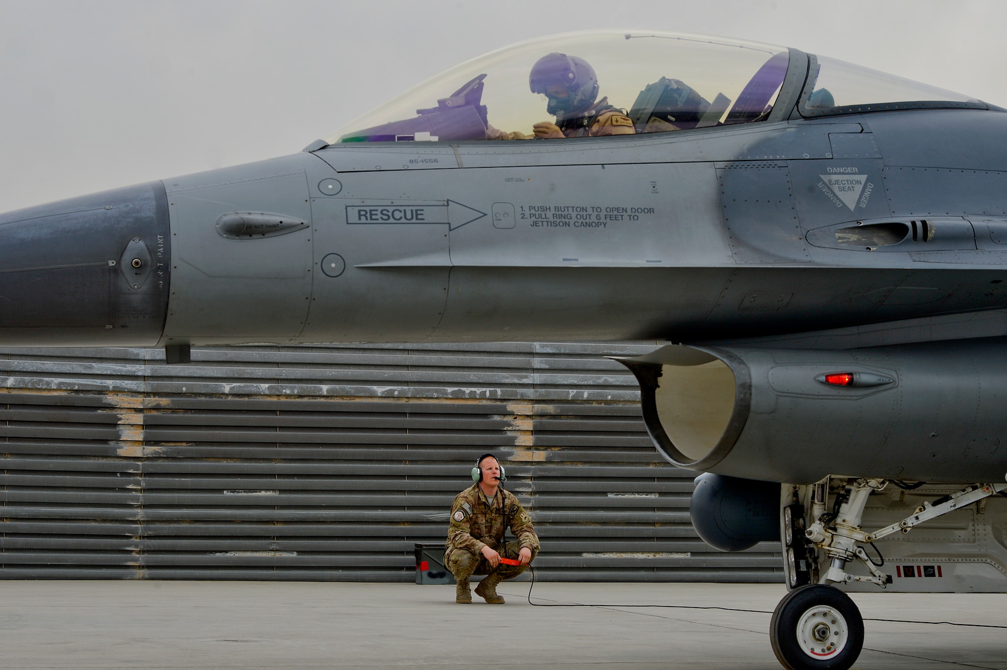 U.S. Air Force Senior Airman Zac Tyson, 455th Expeditionary Aircraft Maintenance Squadron crew chief, conducts preflight checks before an F-16 Fighting Falcon departs at Bagram Airfield, Afghanistan, Feb. 18, 2014. Tyson is deployed from Naval Air Station Joint Reserve Base Fort Worth, Texas, and a native of Farmington, N.M. (U.S. Air Force photo by Senior Airman Kayla Newman/Released)