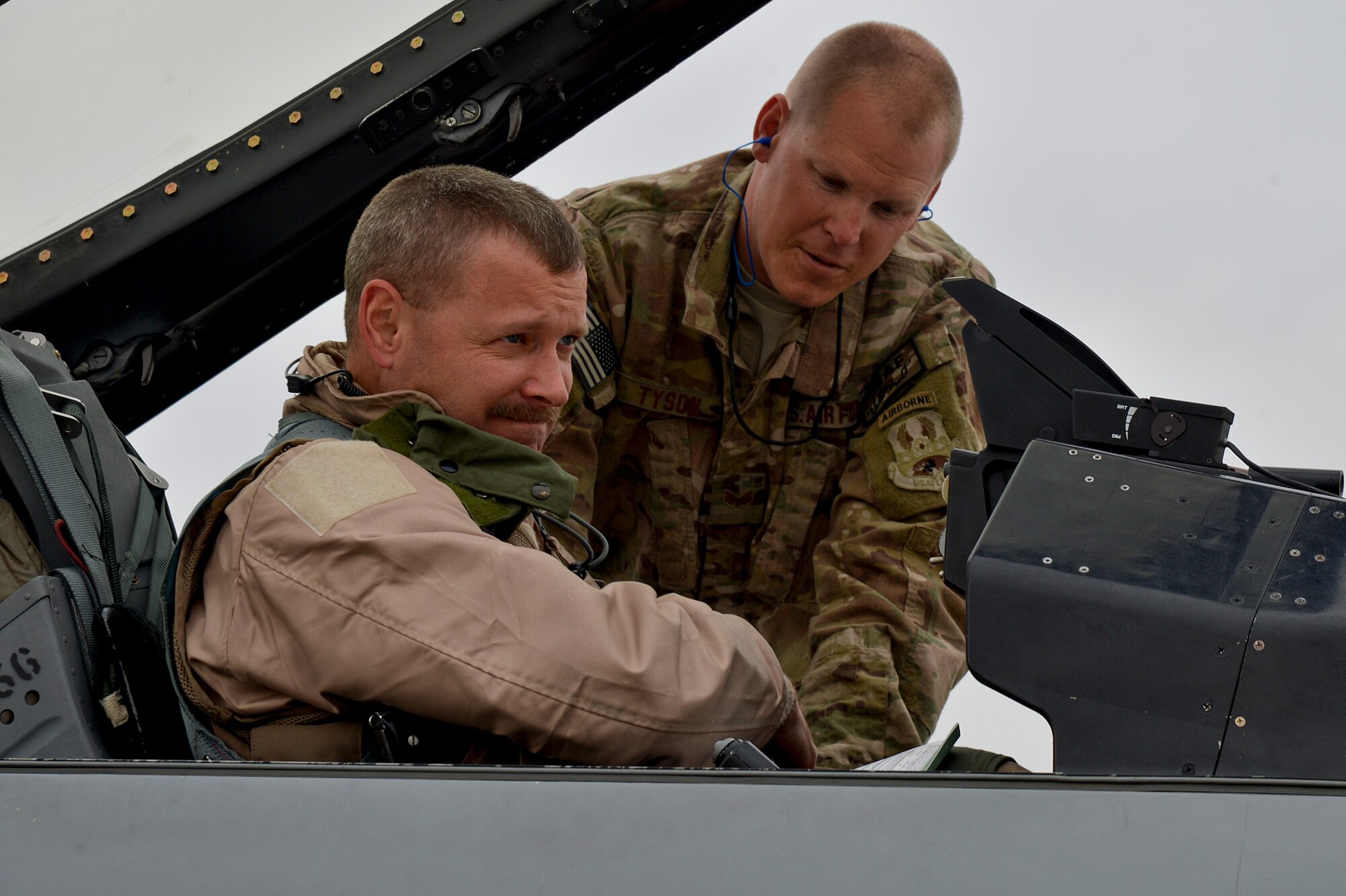 U.S. Air Force Senior Airman Zac Tyson, 455th Expeditionary Aircraft Maintenance Squadron crew chief, secures Lt. Col. Scott Walker, F-16 Fighting Falcon pilot, into an F-16 Fighting Falcon at Bagram Airfield, Afghanistan, Feb. 18, 2014. Walker is deployed from Homestead Air Reserve Base, Fla., and Tyson from Naval Air Station Joint Reserve Base Fort Worth, Texas. (U.S. Air Force photo by Senior Airman Kayla Newman/Released)