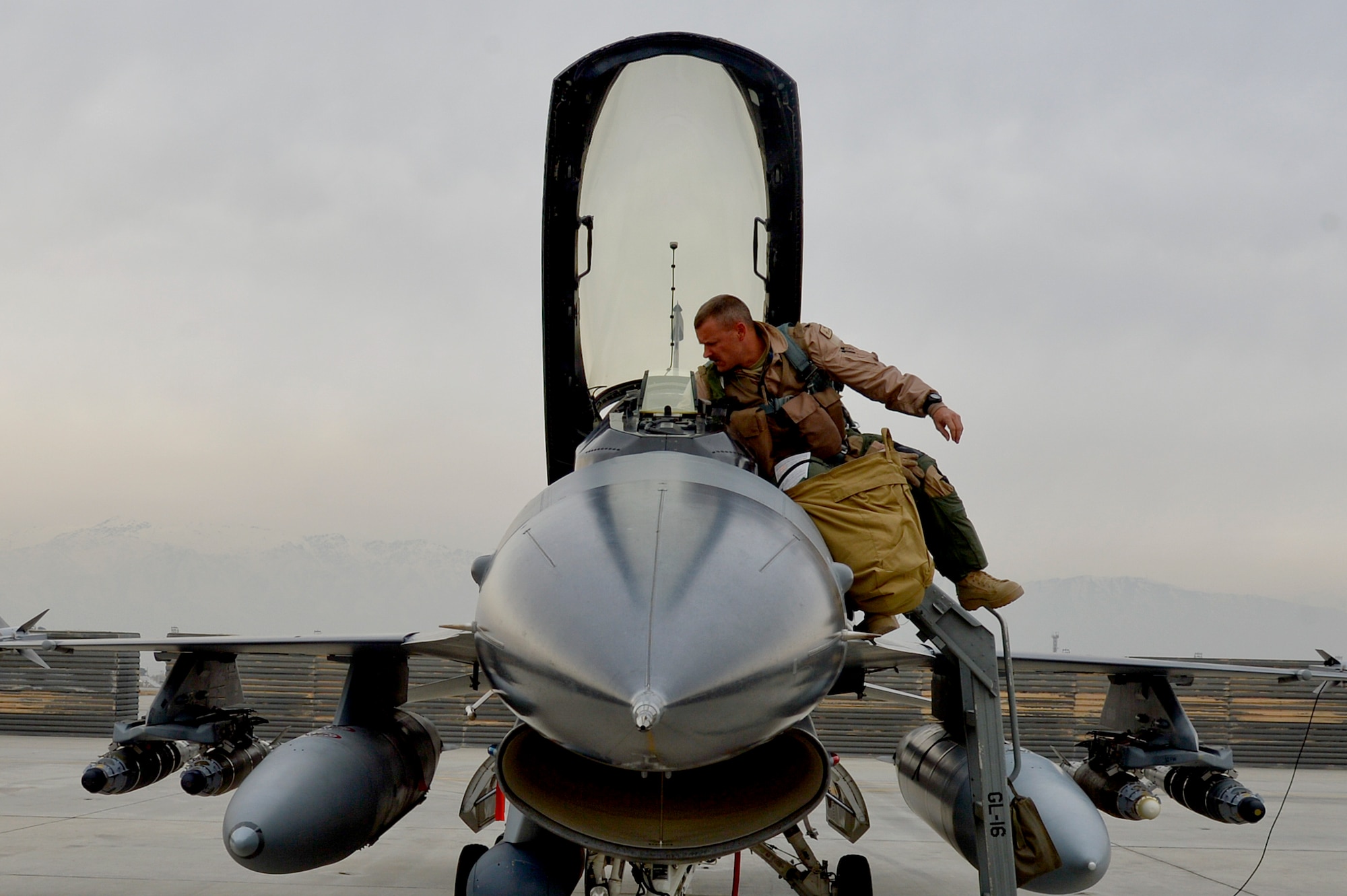 U.S. Air Force Lt. Col. Scott Walker, F-16 Fighting Falcon pilot, prepares to enter an F-16 Fighting Falcon at Bagram Airfield, Afghanistan, Feb. 18, 2014. Walker is the 495th Fighter Group detachment 93 commander from Homestead Air Reserve Base, Fla. (U.S. Air Force photo by Senior Airman Kayla Newman/Released)