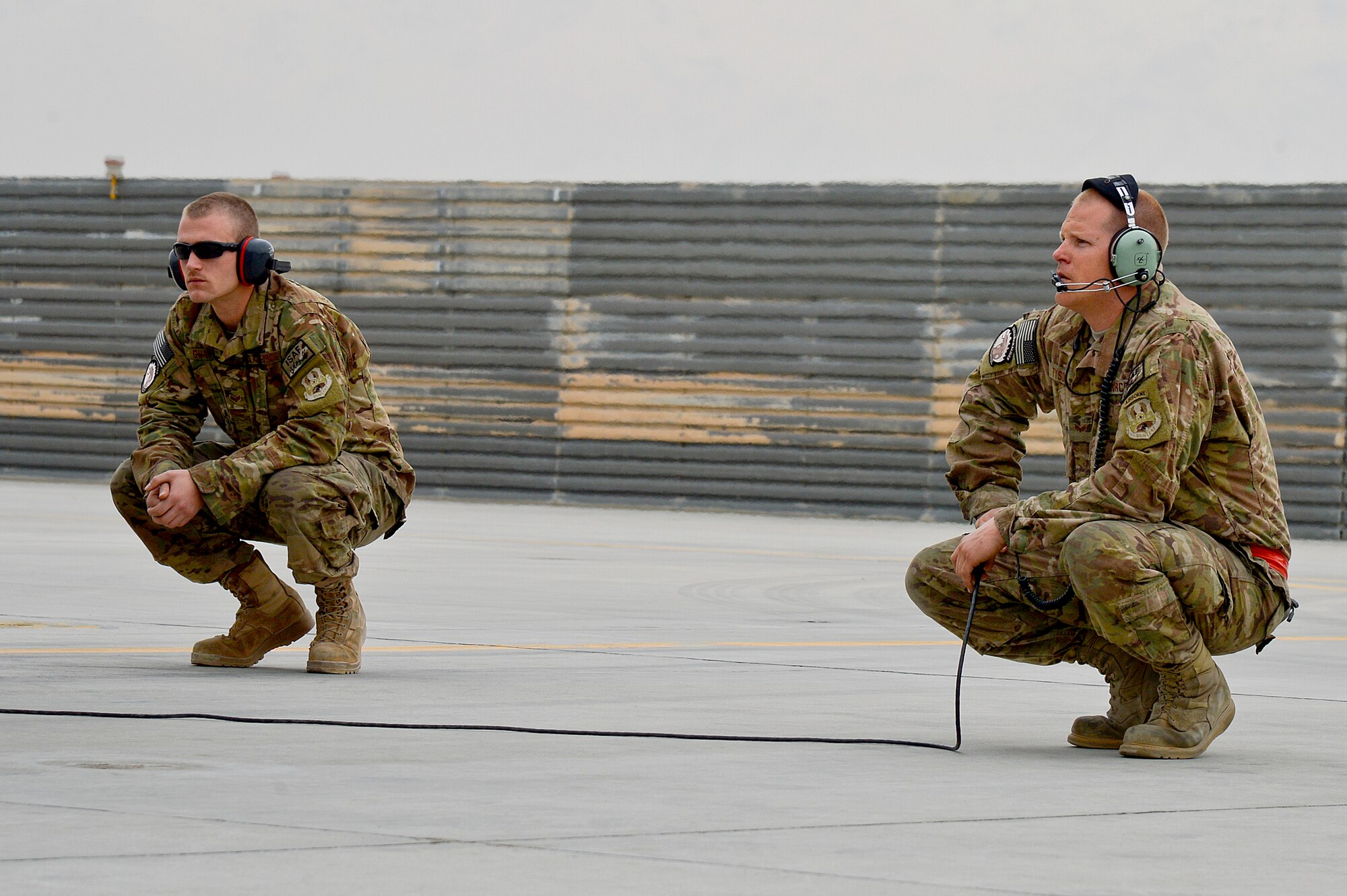 U.S. Air Force Senior Airman’s Jeremy Guay and Zac Tyson, 455th Expeditionary Aircraft Maintenance Squadron crew chiefs, conduct preflight checks on an F-16 Fighting Falcon at Bagram Airfield, Afghanistan, Feb. 18, 2014. The F-16 is deployed from Fort Worth, Texas. (U.S. Air Force photo by Senior Airman Kayla Newman/Released)
