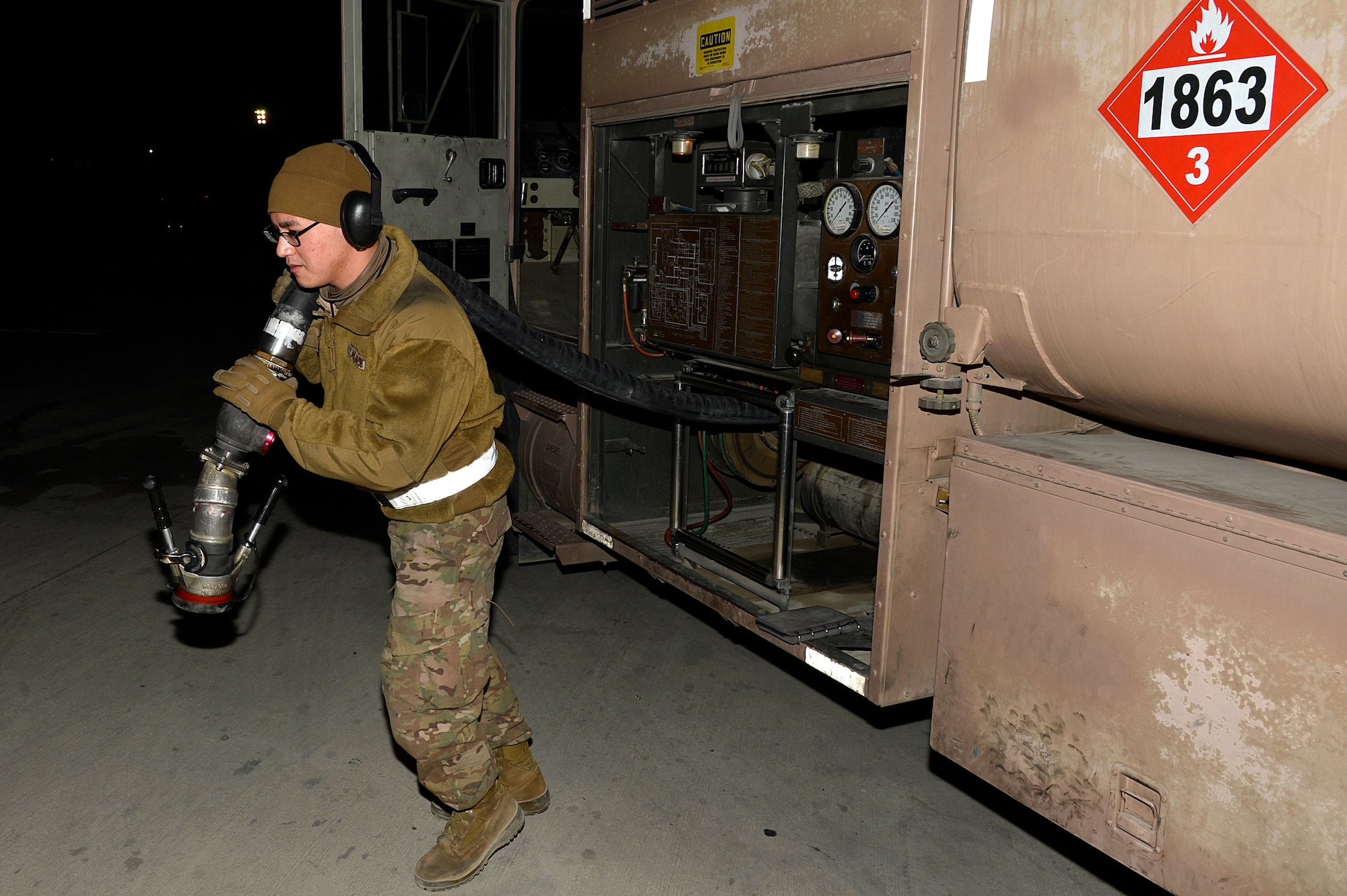 U.S. Air Force Senior Airman Adrian Leyba, 455th Expeditionary Logistics Readiness Squadron fuels operator, prepares to fuel an aircraft at Bagram Airfield, Afghanistan, Feb. 12, 2014. The 455th ELRS POL shop provides clean, dry quality TS-1 aviation fuel for the aircraft using R-11 refueling trucks with 6,000 gallons of fuel. (U.S. Air Force photo by Senior Airman Kayla Newman/Released)