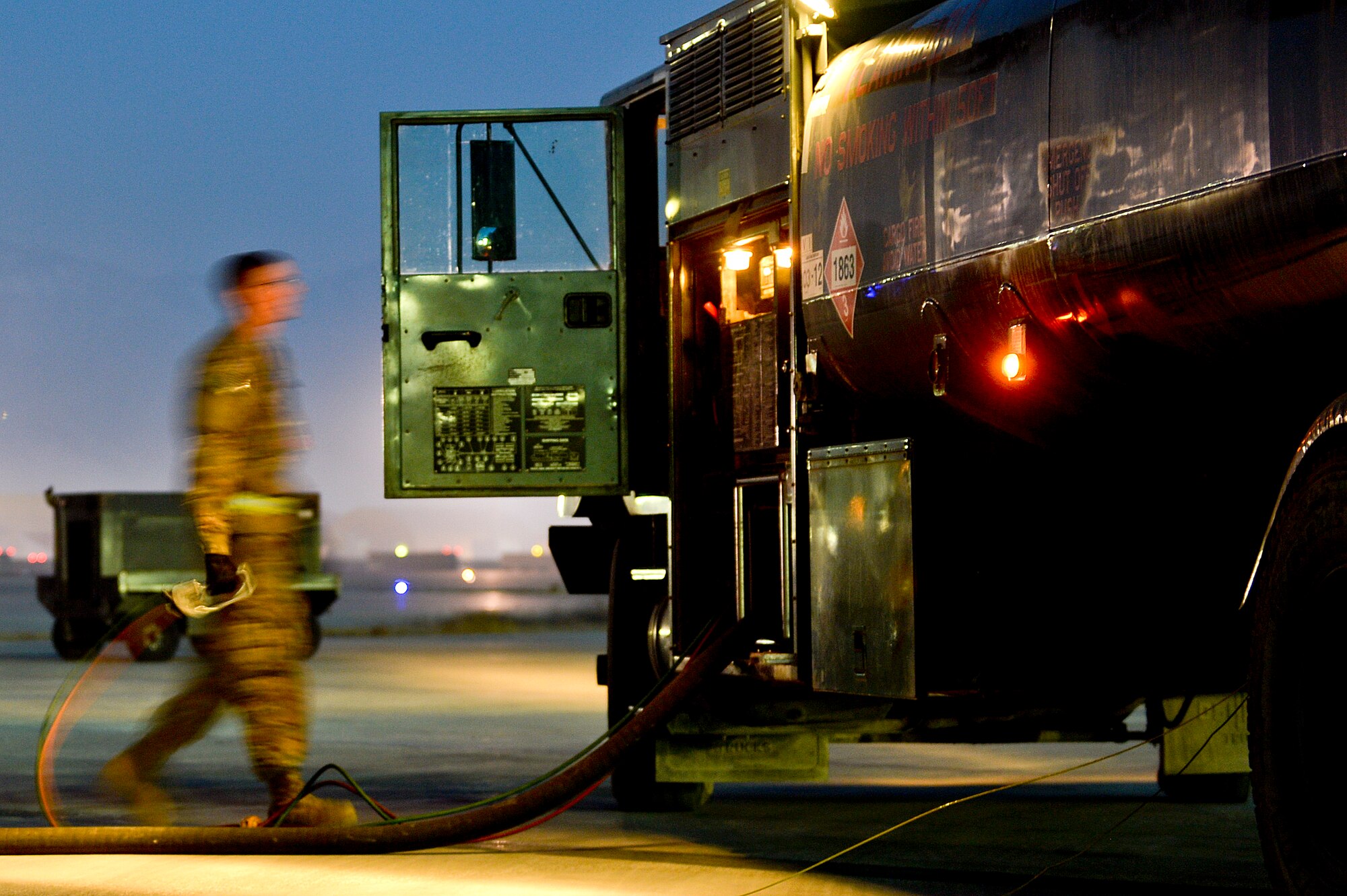 U.S. Air Force Airman 1st Class Cody Smith, 455th Expeditionary Logistics Readiness Squadron fuels operator, fuels an aircraft at Bagram Airfield, Afghanistan, Feb. 12, 2014. The 455th ELRS POL shop provides clean, dry quality TS-1 aviation fuel for the aircraft using R-11 refueling trucks with 6,000 gallons of fuel. (U.S. Air Force photo by Senior Airman Kayla Newman/Released)