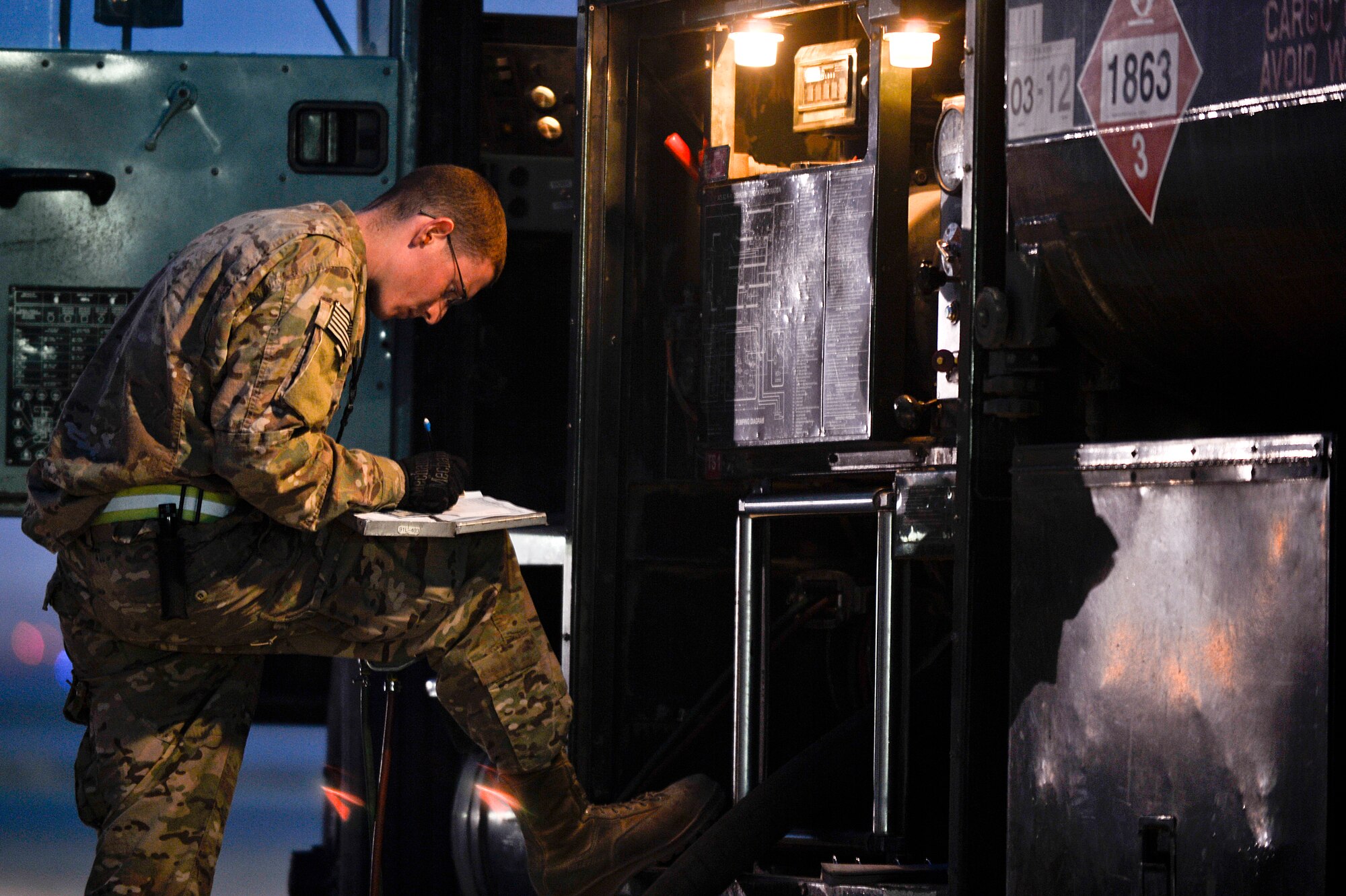U.S. Air Force Airman 1st Class Cody Smith, 455th Expeditionary Logistics Readiness Squadron fuels operator, prepares to fuel an aircraft at Bagram Airfield, Afghanistan, Feb. 12, 2014. The 455th ELRS POL shop provides clean, dry quality TS-1 aviation fuel for the aircraft using R-11 refueling trucks with 6,000 gallons of fuel. (U.S. Air Force photo by Senior Airman Kayla Newman/Released)