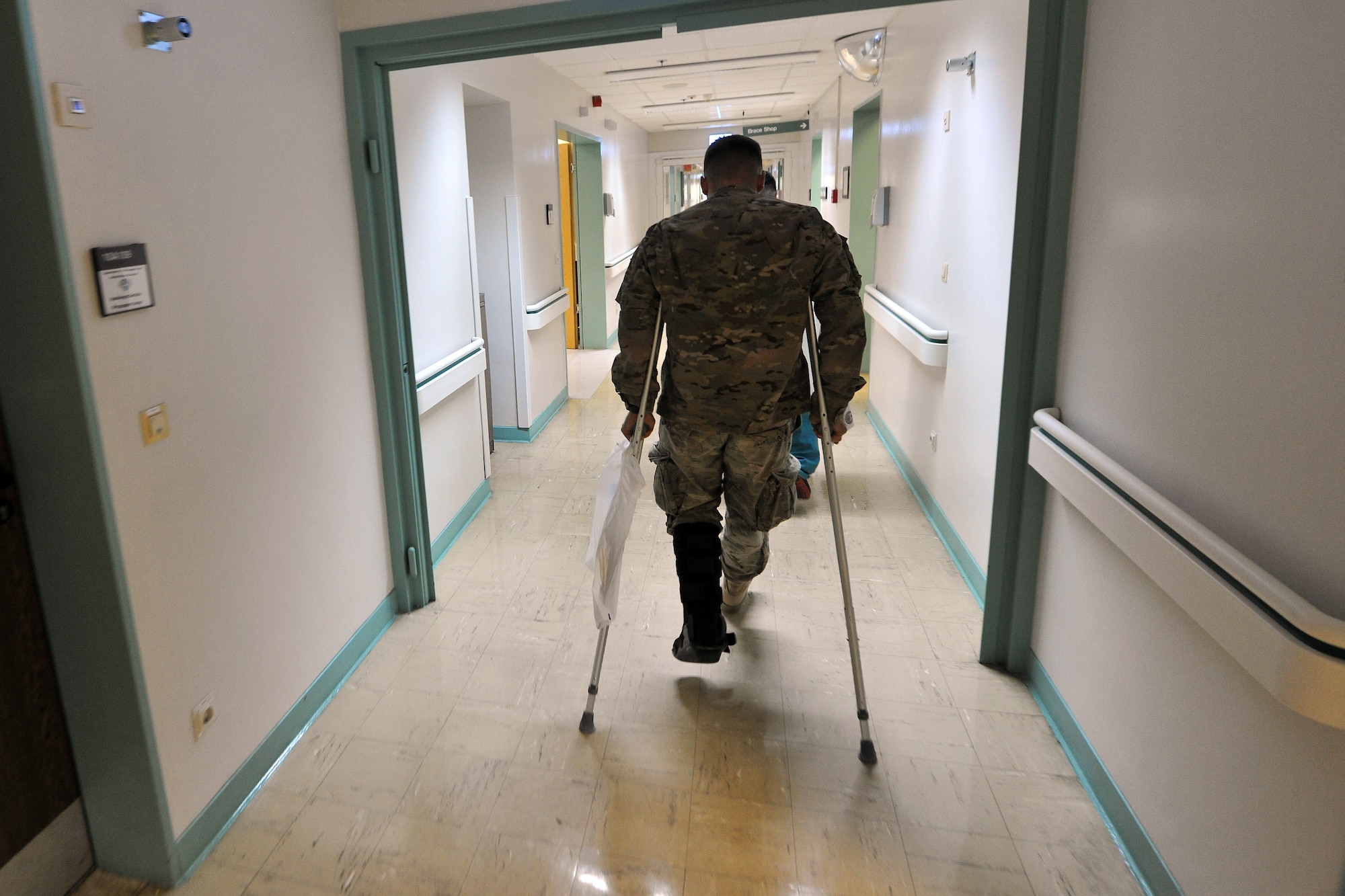 U.S. Army Sgt. Karl Berlinger makes his way to the orthopedic section for his initial observation Feb. 12, 2014, Landstuhl Regional Hospital, Germany.  Berlinger received treatment for his injuries at LRMC within one hour of arrival from Bagram Air Field, Afghanistan.  (U.S. Air Force photo/Senior Airman Chris Willis)