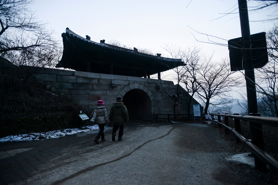 A couple walk under one of the manmade archways in Bukhansan National Park Feb. 16, 2014, in Seoul, Republic of Korea. Bukhansan is nearly 80 kilometers large, and home to the Bukhansanseong Fortress, an ancient defensive structure designed to protect Korea from potential advesaries. (U.S. Air Force photo by Staff Sgt. Jake Barreiro)