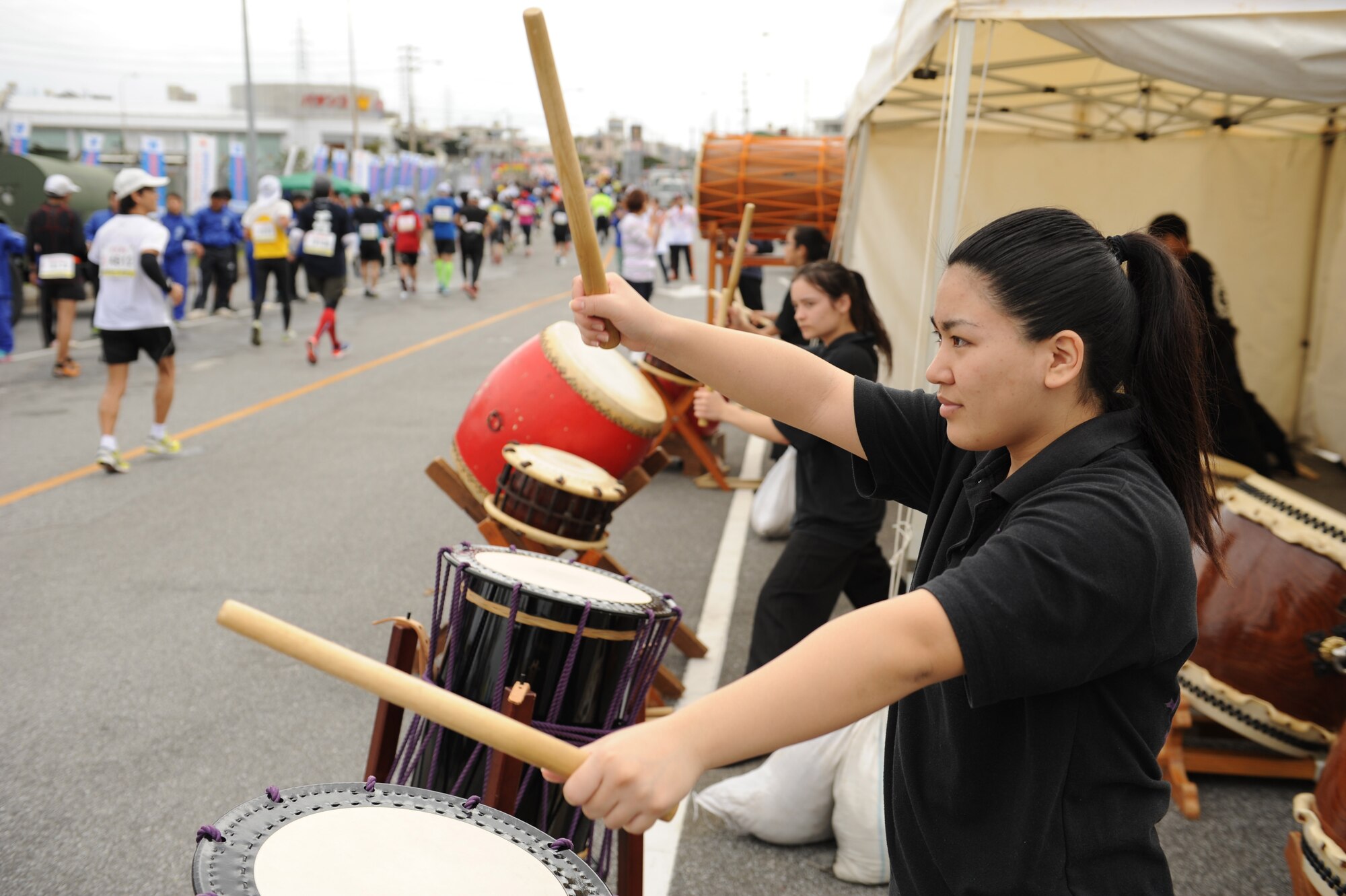 Taiko drummers perform for runners during the 2014 Okinawa Marathon on Kadena Air Base, Japan, Feb. 16, 2014. Hundreds of volunteers handed out water and salt, and cheered the runners on as they ran through the Kadena Air Base portion of the run. (U.S. Air Force photo by Airman 1st Class Keith James)