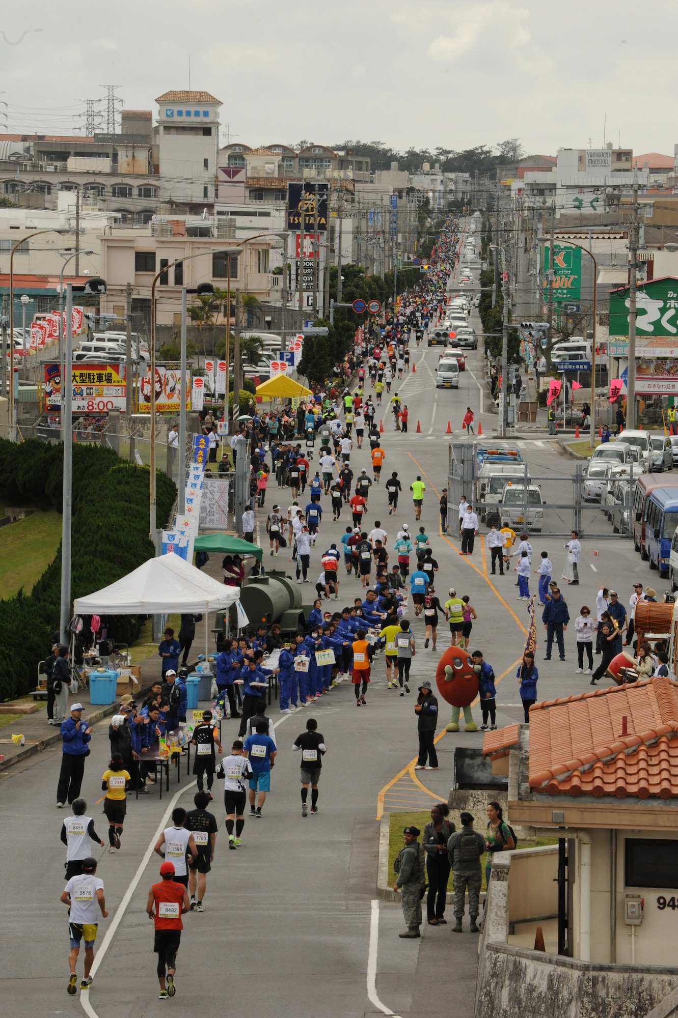 Runners exits Gate 5 completing the Kadena portion of the 2014 Okinawa Marathon, on Kadena Air Base, Japan, Feb. 16, 2014. For 22 years, Kadena has supported the Okinawa Marathon, providing volunteers and opening the base for the 2.8 km route for the runners. (U.S. Air Force photo by Airman 1st Class Keith James)