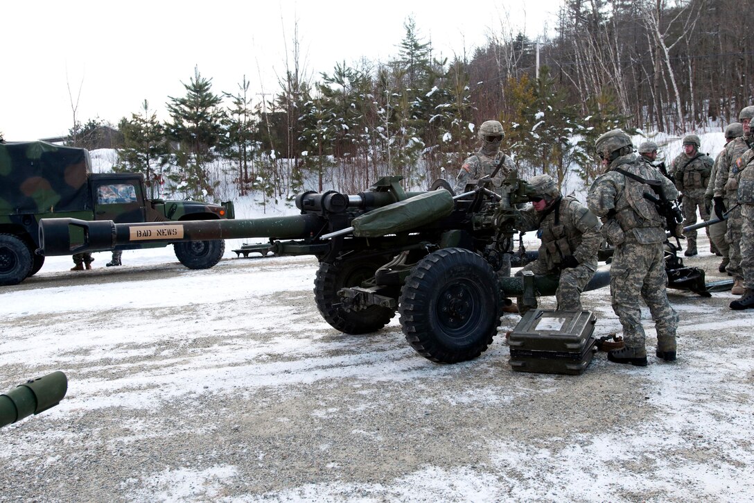 Army Sgt. Matthew Pratt, center, sights in on the M119 howitzer during training operations on Camp Ethan Allen Training Site in Jericho, Vt., Feb. 8, 2014. Pratt is assigned to Vermont National Guard's 1st Battalion, 101st Field Artillery Regiment.