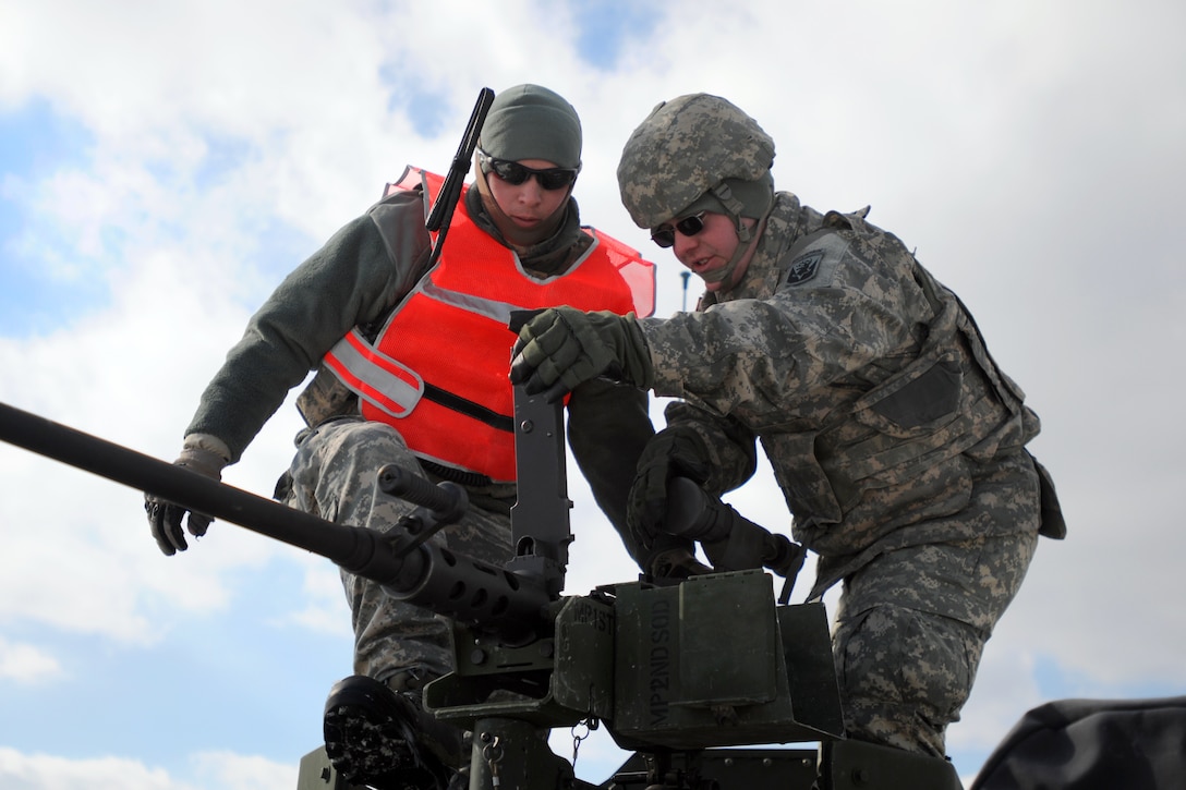 Army Pfc. Stephen Miner performs clearing procedures on the .50-caliber M2 machine gun during weapons qualification on Camp Ethan Allen Training Site in Jericho, Vt., Feb. 8, 2014. Miner is assigned to Vermont National Guard's Headquarters Company, 86th Brigade Special Troops Battalion, Detachment 1 Military Police.