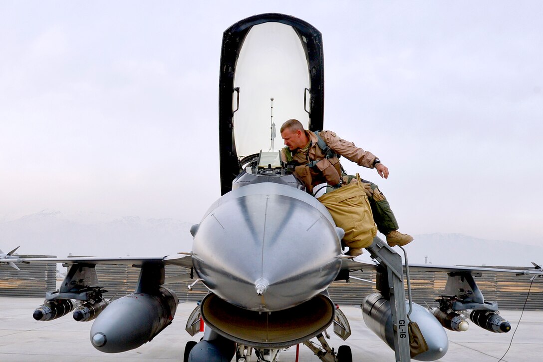U.S. Air Force Lt. Col. Scott Walker prepares to enter an F-16 Fighting Falcon aircraft on Bagram Airfield, Afghanistan, Feb. 18, 2014. Walker, a pilot, is commander of the 495th Fighter Group Detachment 93, Homestead Air Reserve Base, Fla.