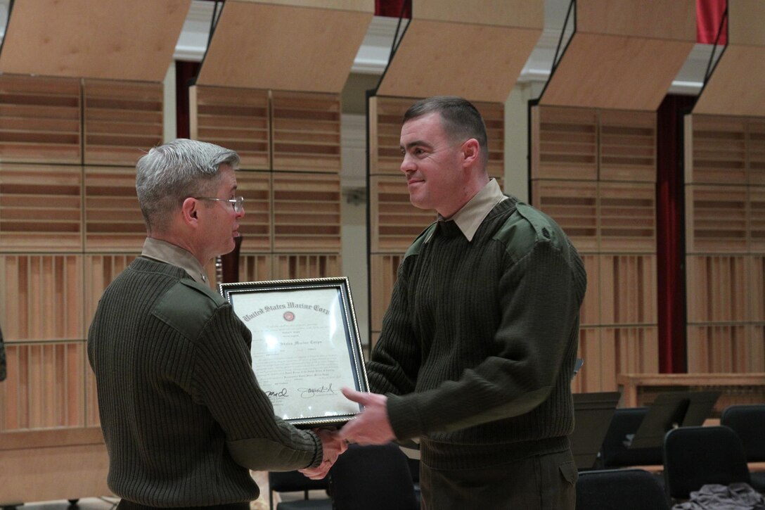 Col. Michael J. Colburn promoted trumpet/cornet player Michael Mergen to master sergeant on Feb. 18, 2014 at the John Philip Sousa Band Hall in Washington, D.C. (U.S. Marine Corps photo by Master Sgt. Kristin S. duBois/released)
