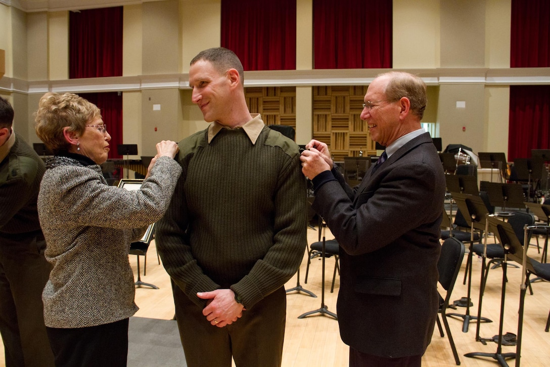 Trumpeter/cornetist Robert Singer was promoted to the rank of Gunnery Sgt. on Feb. 18, 2014 in John Philip Sousa Band Hall. (U.S. Marine Corps photo by Gunnery Sgt. Amanda Simmons/released)