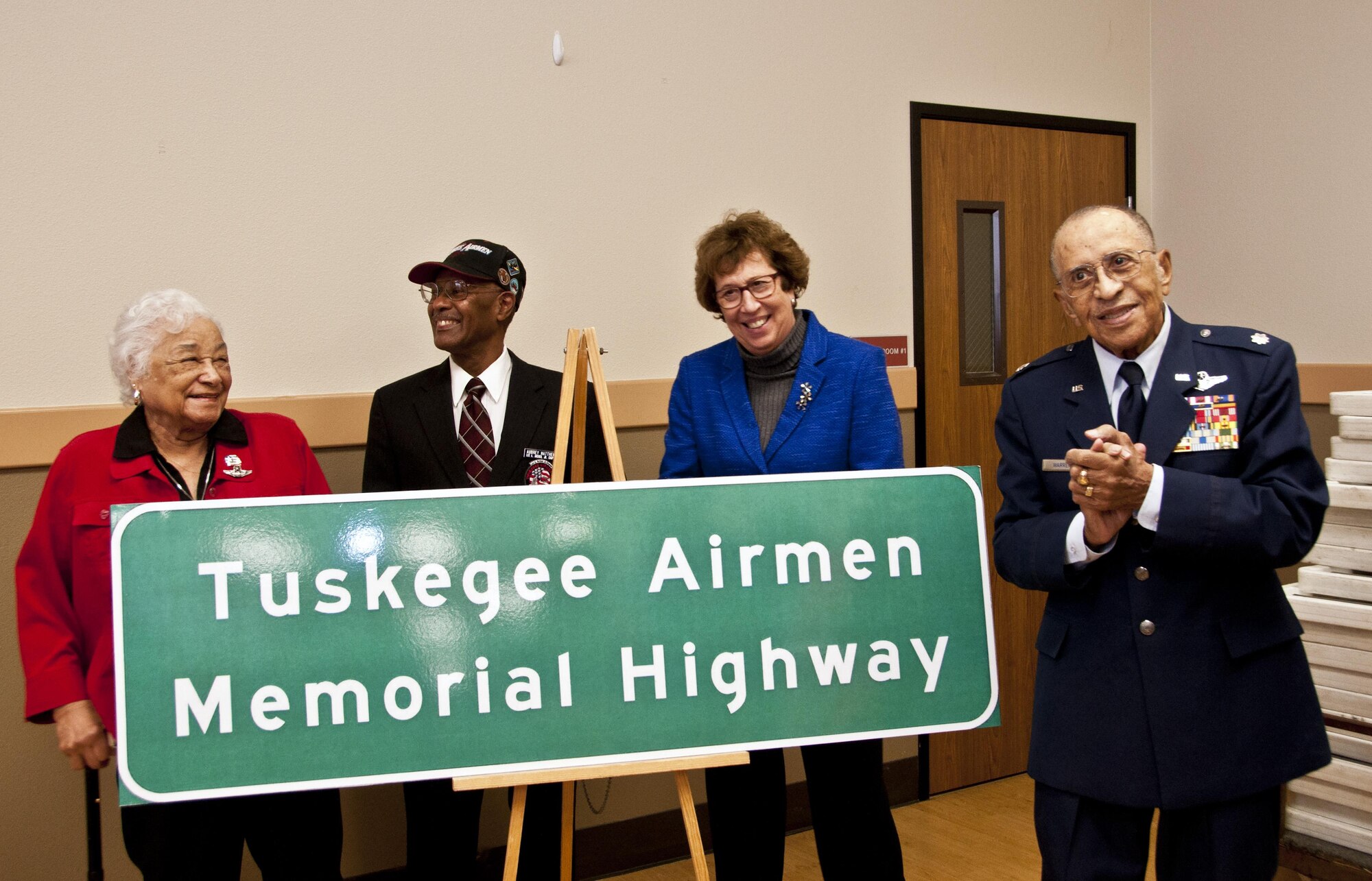 Lt. Col. (ret.) James Warren, Senator Lois Wolk, Aubrey Matthews and Edith Roberts proudly present the Tuskegee Airmen Memorial Highway sign that will be displayed on Interstate 80 Feb. 6 at the Veterans Hall in Dixon, Ca. (U.S. Air Force photo/Senior Airman Madelyn Brown)
 