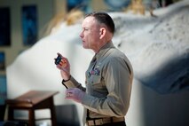 Brig. Gen. Frank Kelley, commander of Marine Corps Systems Command, displays an item unique identification marking that will be attached to an M32A1 multi-shot grenade launcher Feb. 18 at the National Museum of the Marine Corps in Triangle, Va. This was the 1 millionth IUID placed on an item for the Marine Corps. 