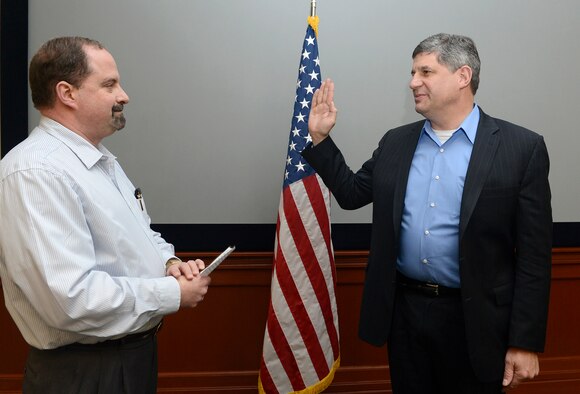 Dr. Bill A. LaPlante is sworn in as the new principal deputy, assistant secretary of the Air Force for acquisition by Timothy Beyland, the administrative assistant to the Secretary of the Air Force, Feb. 18, 2014, at MacDill Air Force Base, Fla.  The confirmation makes LaPlante the first confirmed acquisition senior leader since the position became vacant with the departure of David Van Buren in March 2012.  (U.S. Air Force photo/Scott M. Ash)