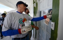 Marine Corps Sgt. Maj. Bryan B. Battaglia, senior enlisted advisor to the chairman of the Joint Chiefs of Staff, talks with a volunteer from Rebuilding Together before starting work on the home of Vietnam veteran Louis Banks in New Orleans, Friday, Feb. 14, 2014, as part of the seventh-annual NBA All-Star Day of Service. About 250 active-duty service members and veterans volunteered to work alongside past and present NBA players on six homes, including the homes of four veterans. (DOD photo by Claudette Roulo)