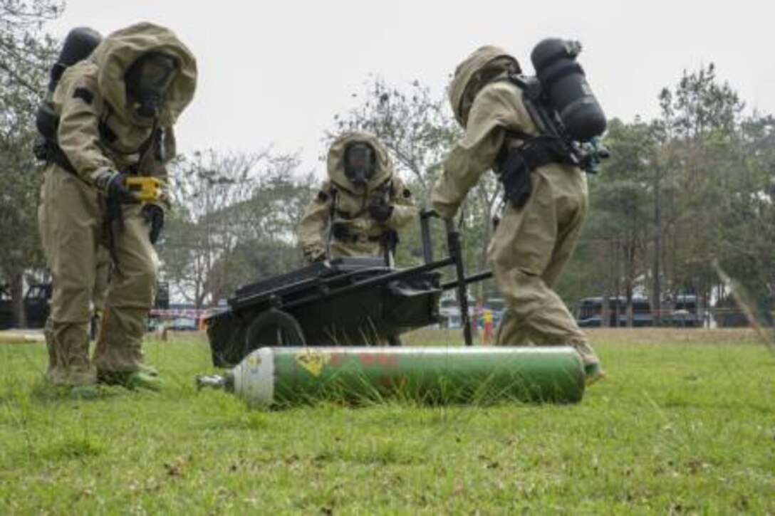 U.S. and Royal Thai Air Force chemical, biological, radiological, nuclear defense specialists work together to contain a cylinder releasing simulated toxic gas during the counter weapons of mass of destruction exercise aboard Wing One Royal Thai Air Force Base, Nakhon Ratchasima, Kingdom of Thailand, Feb. 16 during Exercise Cobra Gold 2014. CG 14 is a joint, multinational exercise conducted annually in the Kingdom of Thailand aimed at enhancing and increasing mission readiness and multinational interoperability. The U.S. service members are with 1st Marine Aircraft Wing, III Marine Expeditionary Force.

