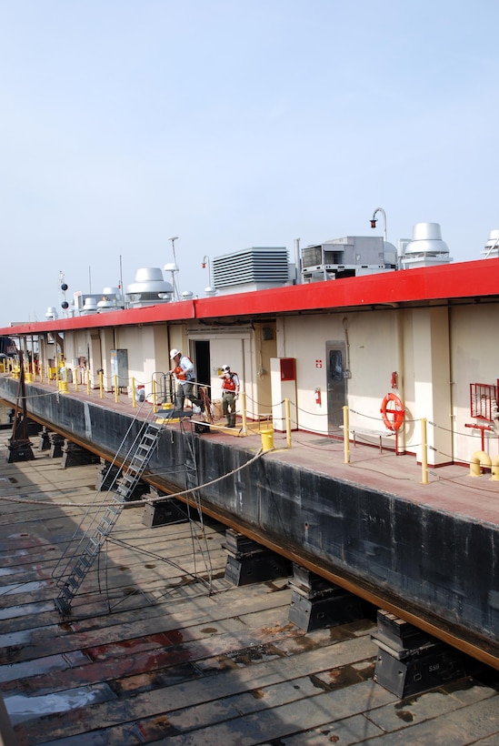 Ensley Engineer Yard and Marine Maintenance Center's Plant Section in operation. Mooring Barge on Dry Dock 5801. Albert Wilson and Brandon Carmack descend the stairs. (USACE Photo/Brenda Beasley)