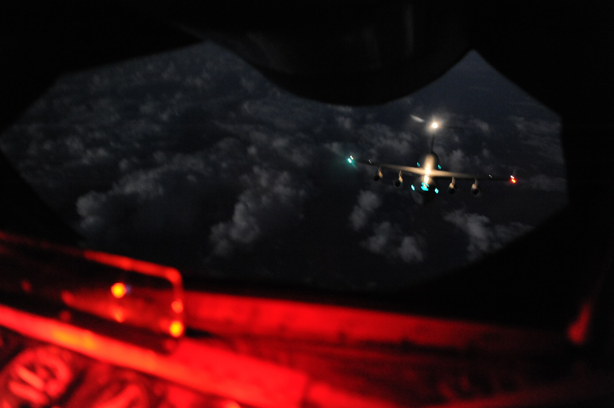 A U.S. Air Force C-17 Globemaster III from the 437th Airlift Wing, Joint Base Charleston, S.C., approaches the boom of a U.S. Air Force KC-135 Stratotanker from the 909th Air Refueling Squadron station at Kadena Air Base, Japan, during an air refueling in support of exercise Cobra Gold 2014. The joint operation between Pacific Air Forces and the Air Mobility Command supported five C-17s being refueled by six KC-135s from McConnell Air Force Base, Kansas, Joint Base Pearl Harbor-Hickam, Hawaii, and Kadena. (U.S. Air Force photo by Airman 1st Class Keith James)