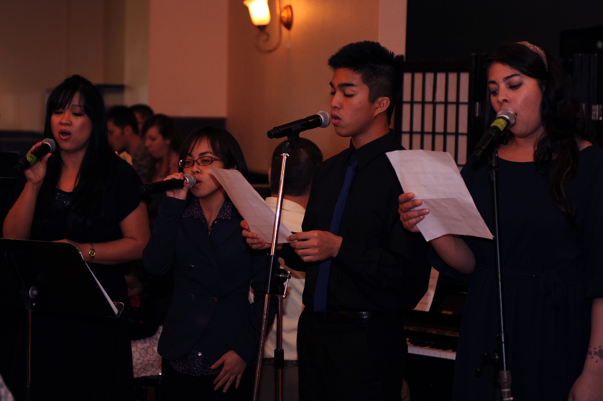 Members of the Kadena Catholic Choir provide music during the National Prayer Luncheon at the Kadena Officer's Club on Kadena Air Base, Japan, Feb. 19, 2014. In 1953, President Eisenhower and members of Congress established the Presidential Prayer Breakfast, now known as the annual National Prayer Breakfast or Luncheon. The Prayer Breakfast brings together the leadership of the United States to affirm our nation's founding moral and spiritual values. (U.S. Air Force photo by Airman 1st Class Hailey R. Staker)