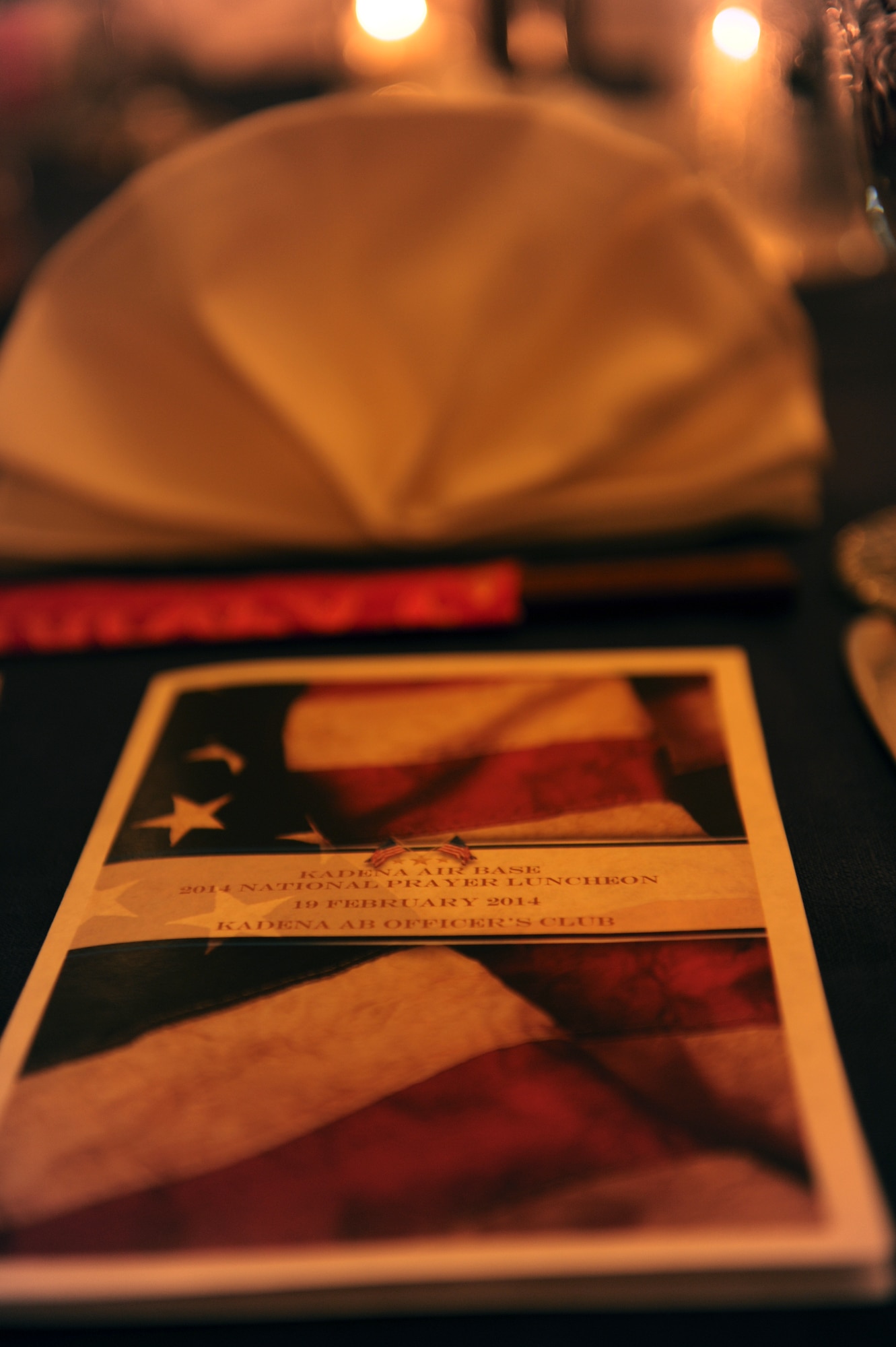 A program brochure, complementary chopsticks and a napkin display sits on a table during the National Prayer Luncheon at the Kadena Officer?s Club on Kadena Air Base, Japan, Feb. 19, 2014. This year marks the 61st anniversary of the National Prayer Breakfast, established by President Eisenhower and members of Congress as the Presidential Prayer Breakfast in 1953. The event brought together base leadership, clergy from the local Okinawan community and other service members and their families across Okinawa. (U.S. Air Force photo by Airman 1st Class Hailey R. Staker) 