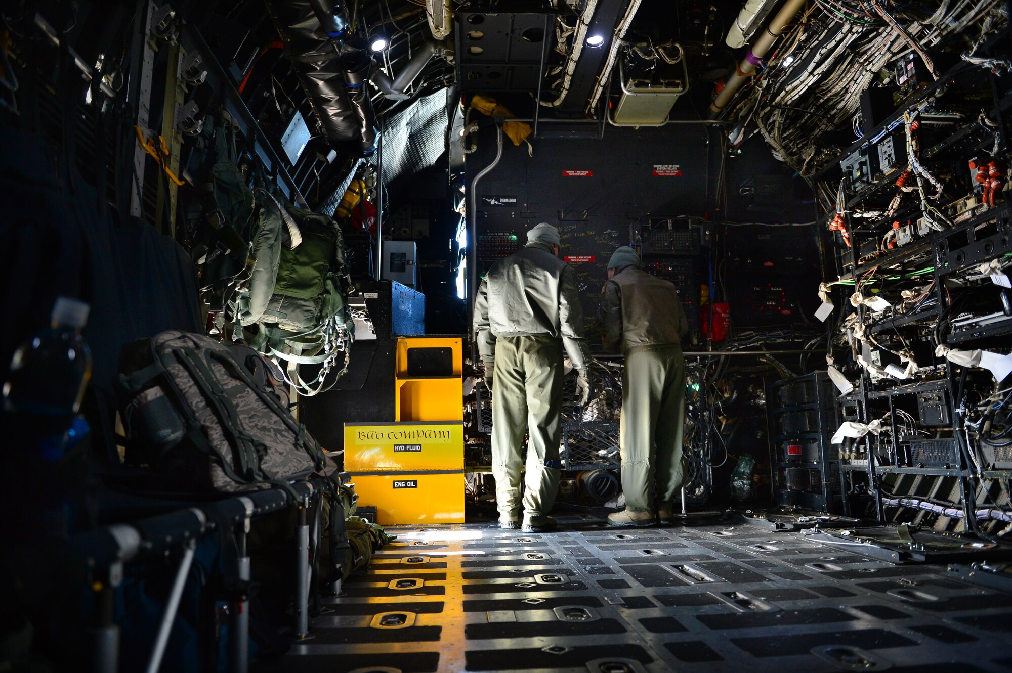 Two aircrew members with the 16th Special Operations Squadron review flight plans aboard the AC-130H Spectre gunship "Bad Company" at Cannon Air Force Base, N.M., Feb. 7, 2014. Built in 1969, Bad Company is the first of six Spectre gunships scheduled to make the trip to Davis-Monthan Air Force Base, Ariz. (U.S. Air Force photo/ Senior Airman Eboni Reece)

