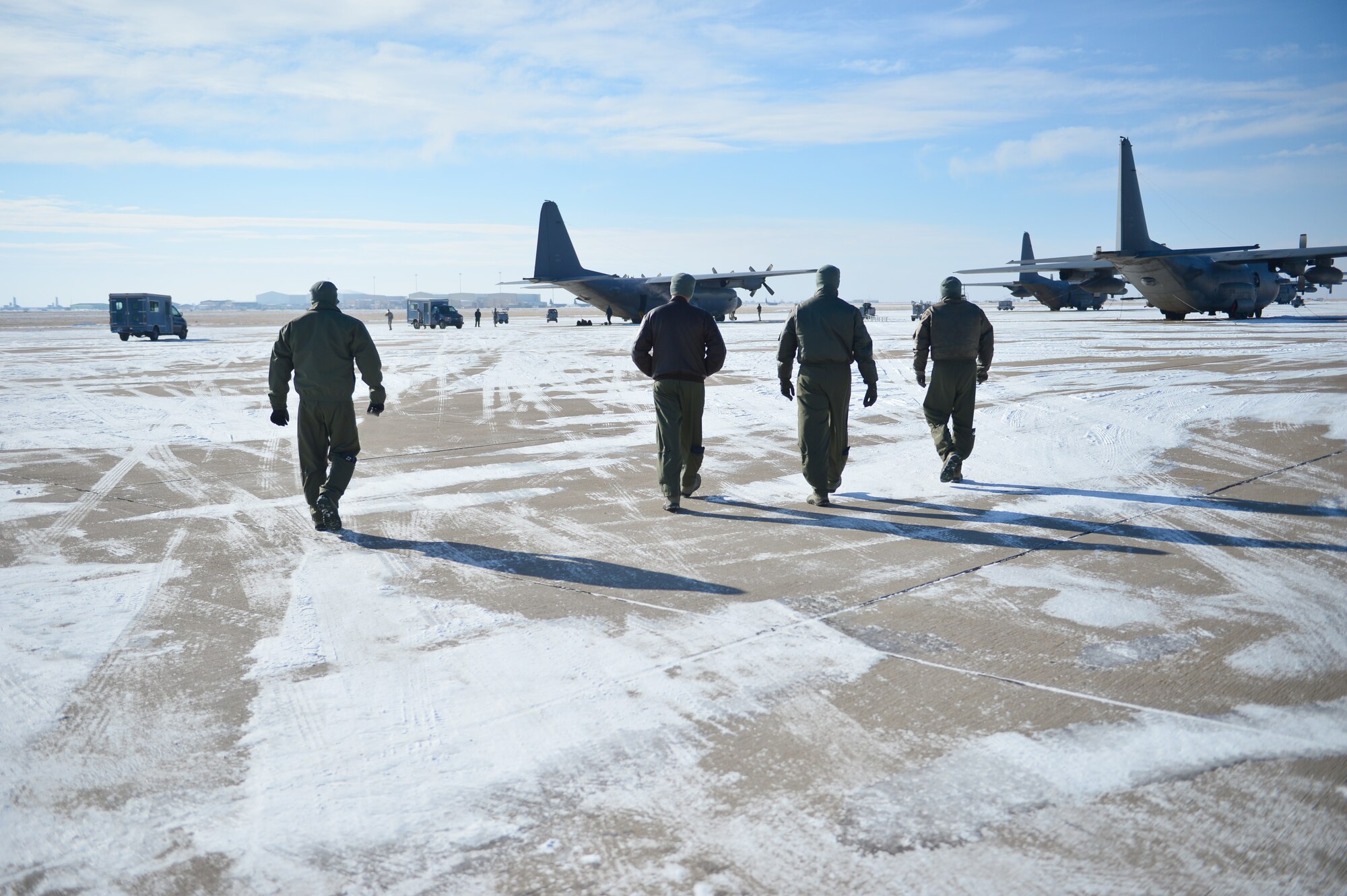 Aircrew members from the 16 Special Operations Squadron walk toward the AC-130H Spectre gunship "Bad Company" on the flightline at Cannon Air Force Base, N.M., Feb. 7, 2014. Built in 1969, Bad Company is the first of six Spectre gunships scheduled to make the trip to Davis-Monthan Air Force Base, Ariz. (U.S. Air Force photo/ Senior Airman Eboni Reece)