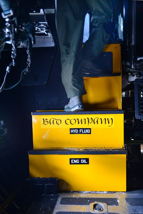 An aircrew member steps up into the cockpit area of the AC-130H Spectre gunship "Bad Company" at Cannon Air Force Base, N.M., Feb. 7, 2014. Having flown since the early 1970s supporting armed forces during the Vietnam War, Bad Company has also had involvement in every major combat operation in Iraq, Iran, Afghanistan, Bosnia and Panama until present day. (U.S. Air Force photo/ Senior Airman Eboni Reece)