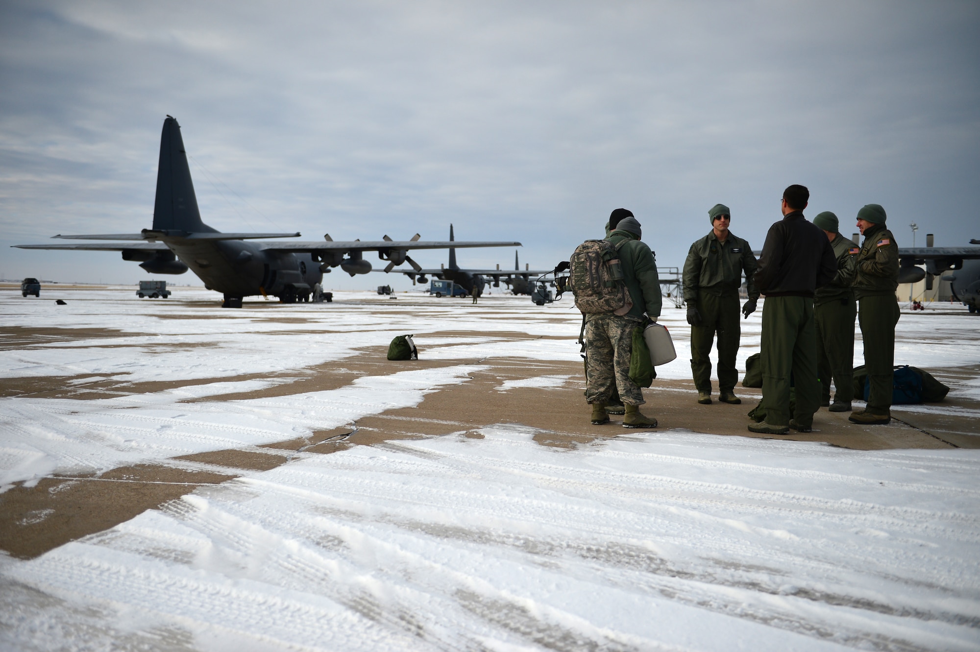 Aircrew members from the 16th Special Operations Squadron await the take-off of the AC-130H Spectre gunship "Bad Company" on the flightline at Cannon Air Force Base, N.M., Feb. 7, 2014. Built in 1969, Bad Company is the first of six Spectre gunships scheduled to make the trip to Davis-Monthan Air Force Base, Ariz. (U.S. Air Force photo/ Senior Airman Eboni Reece)

