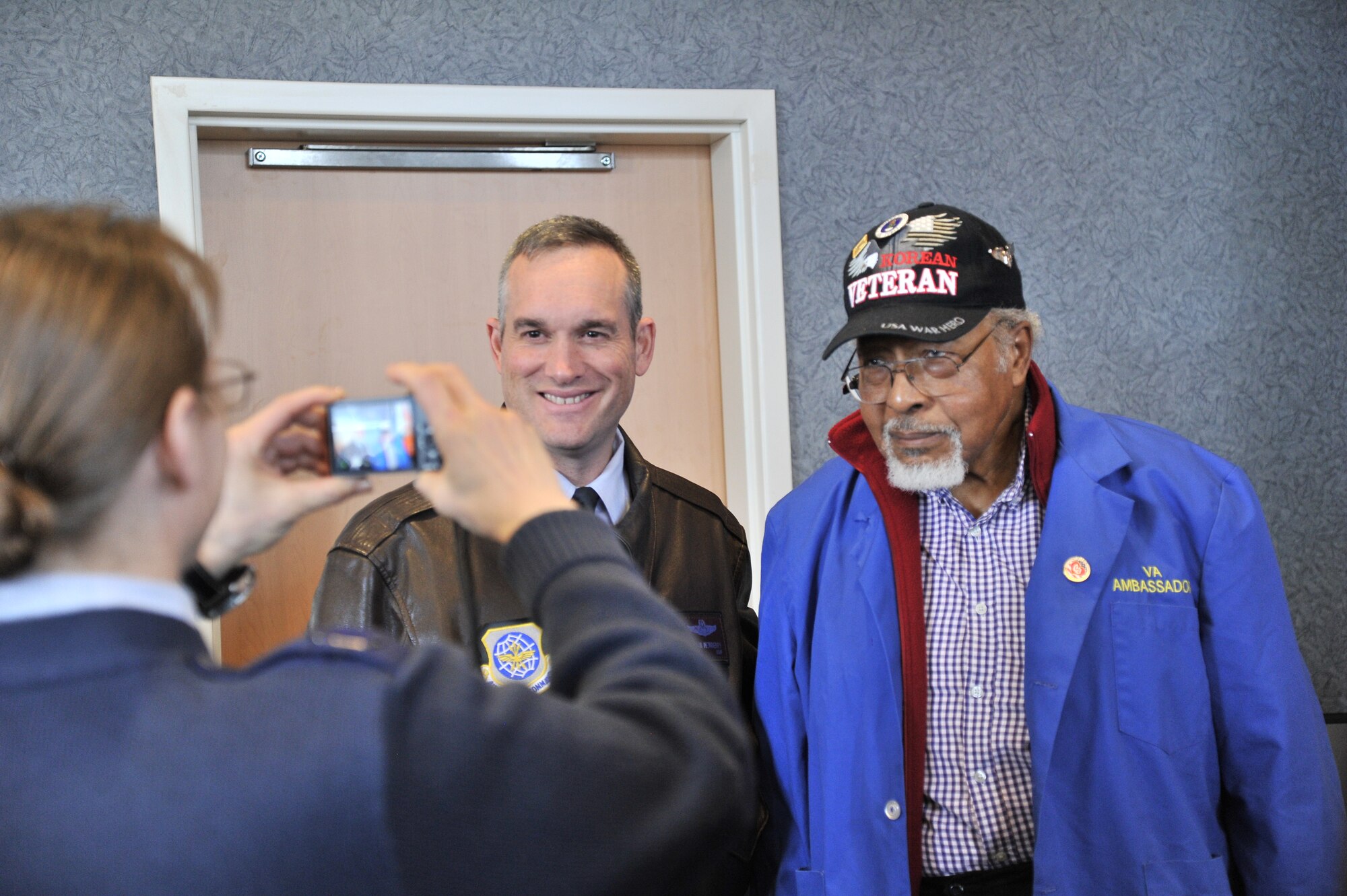 Col. Brian Newberry, the 92nd Air Refueling Wing commander, takes a photo with Paul Bigsby, a Spokane Veterans Affairs Medical Center ambassador, while meeting and visiting staff and veterans at the Spokane VAMC facilities in Spokane Wash., Feb. 14, 2014. The Spokane VAMC is dedicated to providing quality health care services to veterans. In carrying out this mission, the VAMC focuses on providing primary and secondary care, with emphasis on preventive health and chronic disease management. Sharing agreements exist with the 92nd Medical Group at Fairchild AFB, Indian Health Services for Native Americans, and the Idaho and Washington State Departments of Veterans Affairs for the care of state home residents in Lewiston, Idaho, and Spokane. (U.S. Air Force photo by Staff Sgt. Alexandre Montes/Released) 