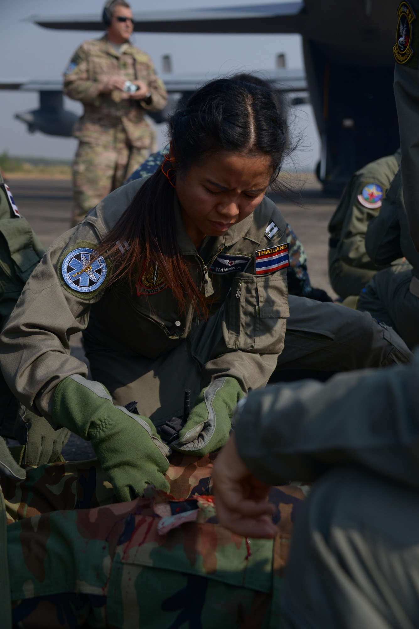 A member from the Royal Thai Air Force applies a tourniquet to a patient during a combat casualty fly-away exercise during Teak Torch Feb. 6, 2014 in Udon Thani, Thailand.   Members of the Royal Thai Air Force and the 353rd Special Operations Support Squadron, Operation Support Medicine, came together during the training exchange to share techniques in combat casualty evacuations and tactical combat casualty care.  (U.S. Air Force photo by Tech. Sgt. Kristine Dreyer)