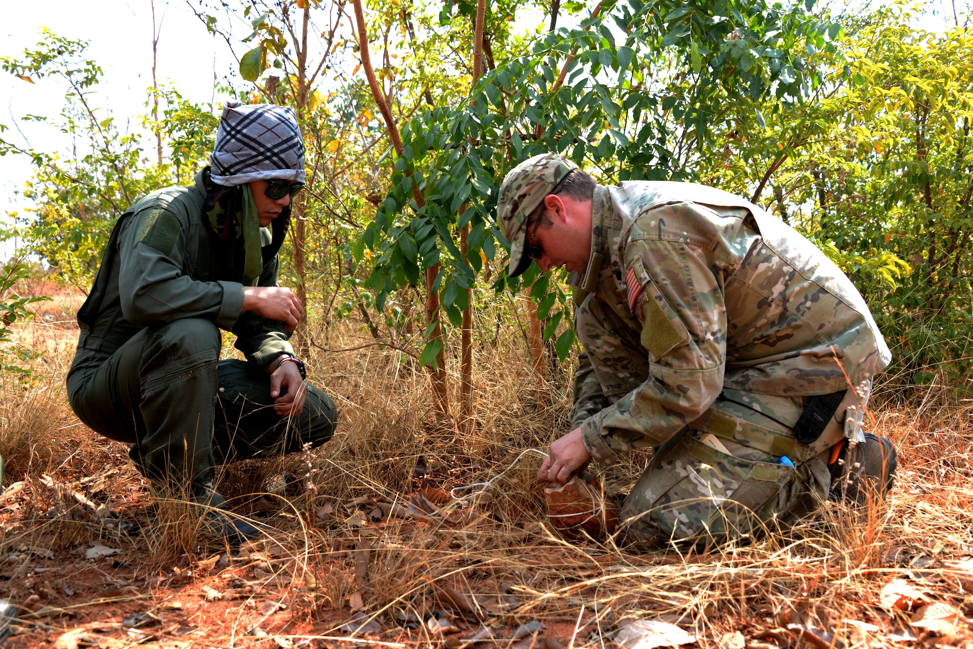 Tech. Sgt. Cody Lefever, 353rd Special Operations Support Squadron, Survival, Evasion, Resistance and Escape specialist demonstrates how to build a snare during a land survival exchange with U.S. Air Force and Royal Thai Air Force pilots Feb. 4, 2014 at a range near Udon Thani, Thailand. (U.S. Air Force photo by Tech. Sgt. Kristine Dreyer)