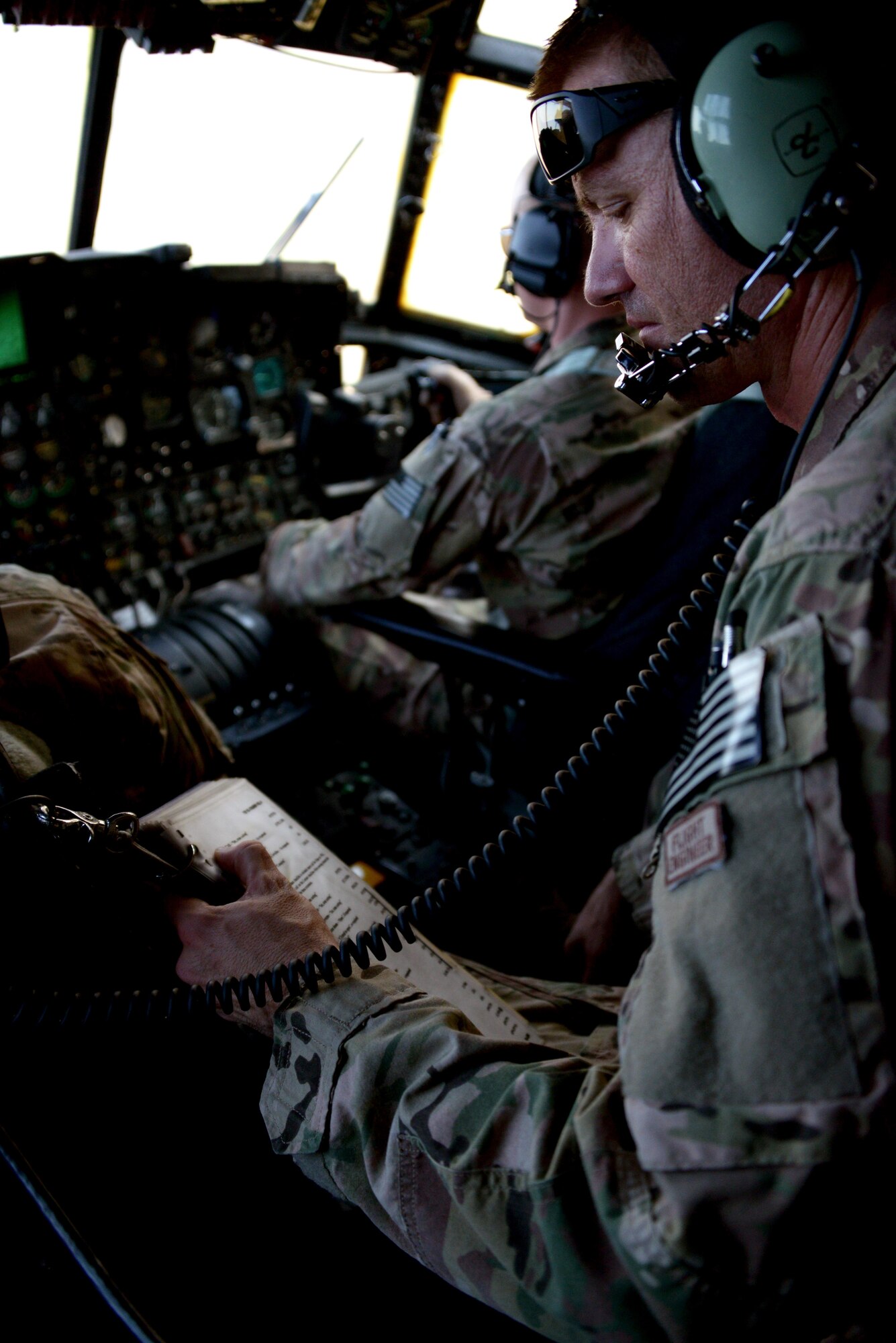 Master Sgt. Jason Litz, a flight engineer from the 17th Special Operations Squadron, runs through his checklist during formation low level flying near Udon Thani, Thailand, Feb. 3, 2014.  The MC-130P Combat Shadows from the 17th SOS are part of the 353rd Special Operations Group detachment from Kadena Air Base, Japan, in Udon Thani, Thailand, to participate in Exercise Teak Torch.  (U.S. Air Force photo by Tech. Sgt. Kristine Dreyer)
