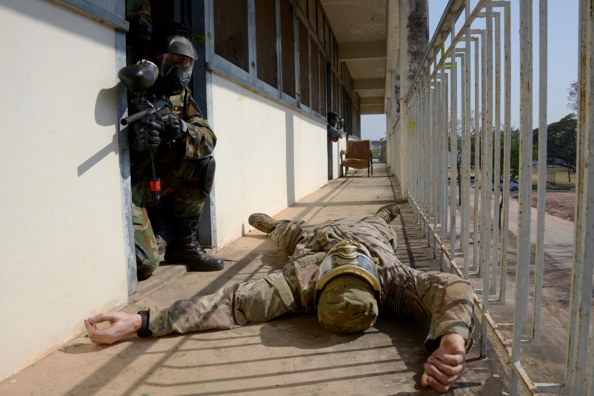 Two members from the Royal Thai Air Force Security Forces provides security as the rest of the team clears the rooms during a close quarter combat training scenario held Jan. 31, 2014 during Exercise Teak Torch in Udon Thani, Thailand. The scenario-based training gave both the 353rd Special Operations Support Squadron Deployed Aircraft Ground Response Element Team and their Royal Thai Air Force counterparts an opportunity to share different tactics and techniques.  (U.S. Air Force photo by Tech. Sgt. Kristine Dreyer)