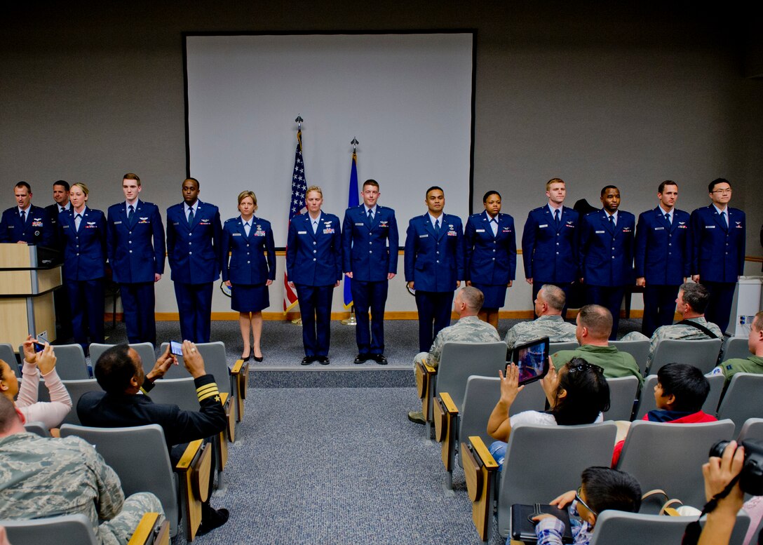 Air Battle Management training class 14007 graduates stand on stage in the 337th Air Control Squadron Auditorium after graduating Feb. 19, 2014. (U.S. Air Force photo by Senior Airman Christopher Reel)