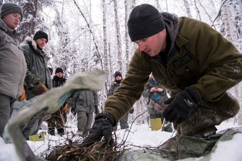 U.S. Air Force Tech. Sgt. Justin Carson, Detachment 1, 66th Training Squadron survival evasion resistance and escape specialist, prepares to start a fire during Artic Survival School training Feb. 6, 2014, Eielson Air Force Base, Alaska. Starting a fire was one of the many skills taught during the week-long “Cool School.” (U.S. Air Force photo by Senior Airman Joshua Turner/Released)