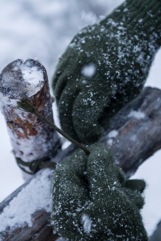 A student prepares to build a thermalized A-frame shelter during Artic Survival School training Feb. 6, 2014, Eielson Air Force Base, Alaska. A portion of the training requires students to construct a shelter to sleep in through the night. (U.S. Air Force photo by Senior Airman Joshua Turner/Released)