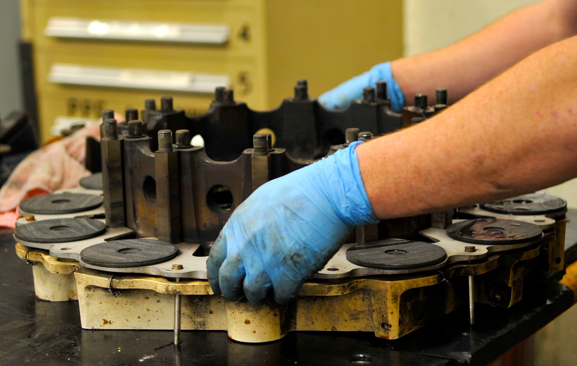Airman 1st Class Jeremy Smith, 2nd Maintenance Squadron hydraulics systems journeyman, removes the layers of a B-52H Stratofortress brake on Barksdale Air Force Base, La., Feb. 14, 2014. The metal parts were washed in a machine before being reassembled and tested. (U.S. Air Force Photo/Airman 1st Class Benjamin Raughton)