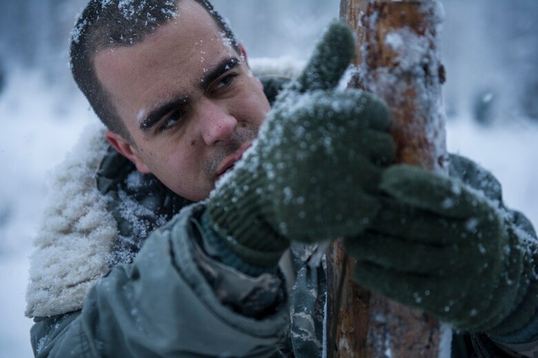 U.S. Air Force 2nd Lt. Elias Zani, 354th Fighter Wing Public Affairs deputy public affairs officer, prepares to build a thermalized A-frame shelter during Artic Survival School training Feb. 6, 2014, Eielson Air Force Base, Alaska. A portion of the training required Zani to construct a shelter to sleep in through the night. (U.S. Air Force photo by Senior Airman Joshua Turner/Released)