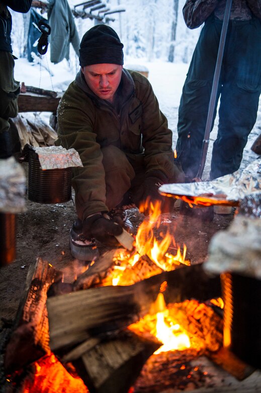 U.S. Air Force Tech. Sgt. Justin Carson, Detachment 1, 66th Training Squadron survival evasion resistance and escape specialist, prepares to cook a squirrel Feb. 6, 2014, Eielson Air Force Base, Alaska. Carson is tasked with providing arctic survival training to U.S. military and allies. As part of the training, the students set up snares to catch small game. (U.S. Air Force photo by Senior Airman Joshua Turner/Released)