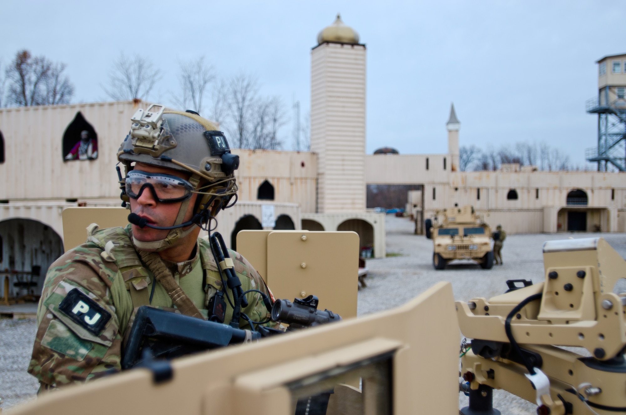 A member of the Kentucky Air National Guard’s 123rd Special Tactics Squadron defends a vehicle during training at Zussman Range at Fort Knox, Ky., on Nov. 21, 2013. The Airman and his teammates were practicing insertions, extractions and close-quarters combat in a simulated Afghan village. (U.S. Air National Guard photo by Master Sgt. Phil Speck)