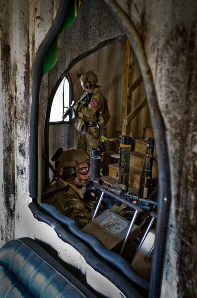 Two members of the Kentucky Air National Guard’s 123rd Special Tactics Squadron guard a found-weapons cache during a training exercise at Zussman Range at Fort Knox, Ky., on Nov. 21, 2013. The Airmen were practicing insertions, extractions and close-quarters combat in a simulated Afghan village. (U.S. Air National Guard photo by Master Sgt. Phil Speck)