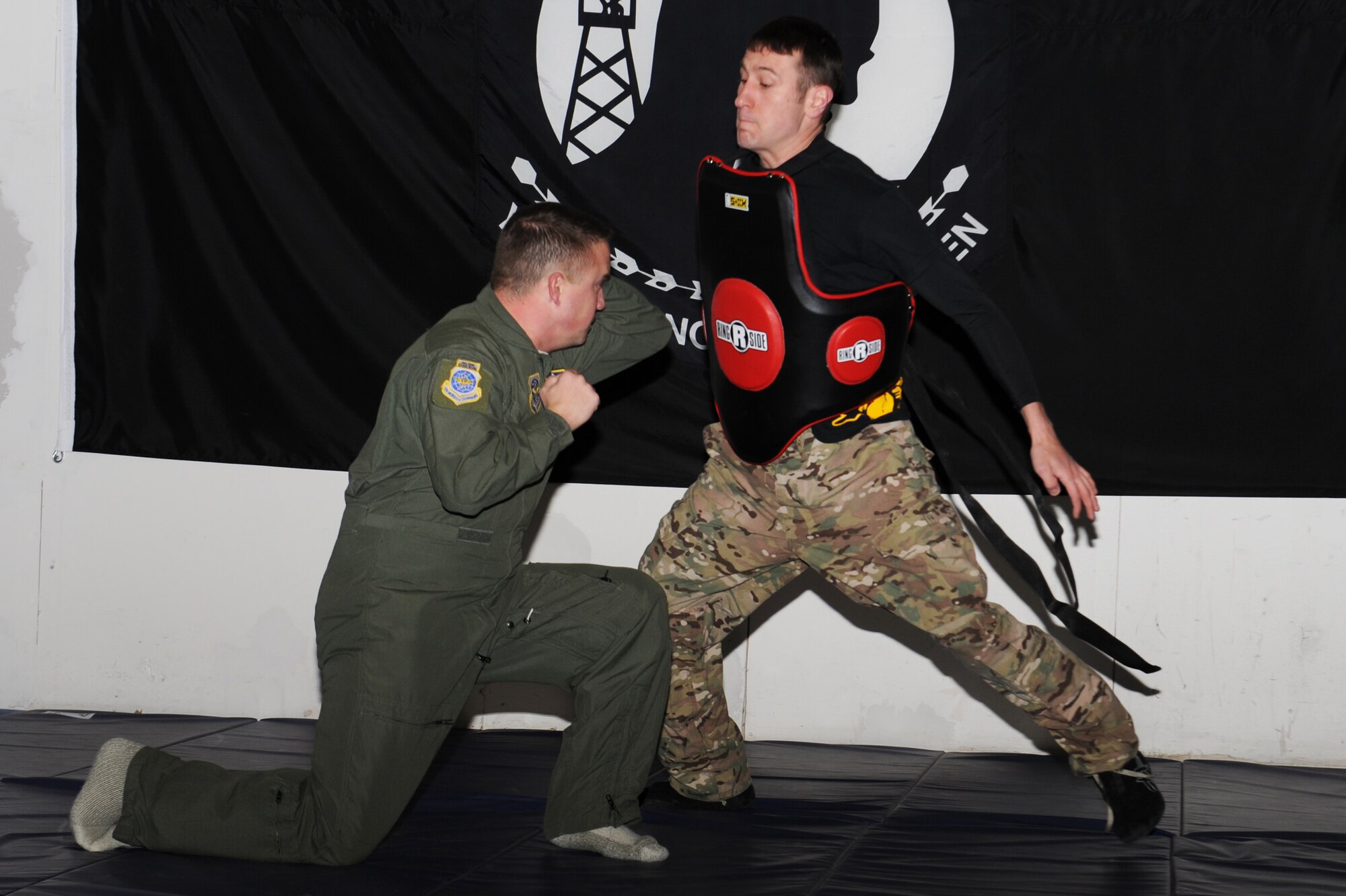 Master Sgt. Jamie Smith demonstrates an elbow strike on Senior Airman Kyle Owens during the training and learned hand-to-hand combat training techniques. Smith is with Air Mobility Command headquarters and Owens is with the 375th Operations Support Squadron. (U.S. Air Force photo/Airman 1st Class Megan Friedl)