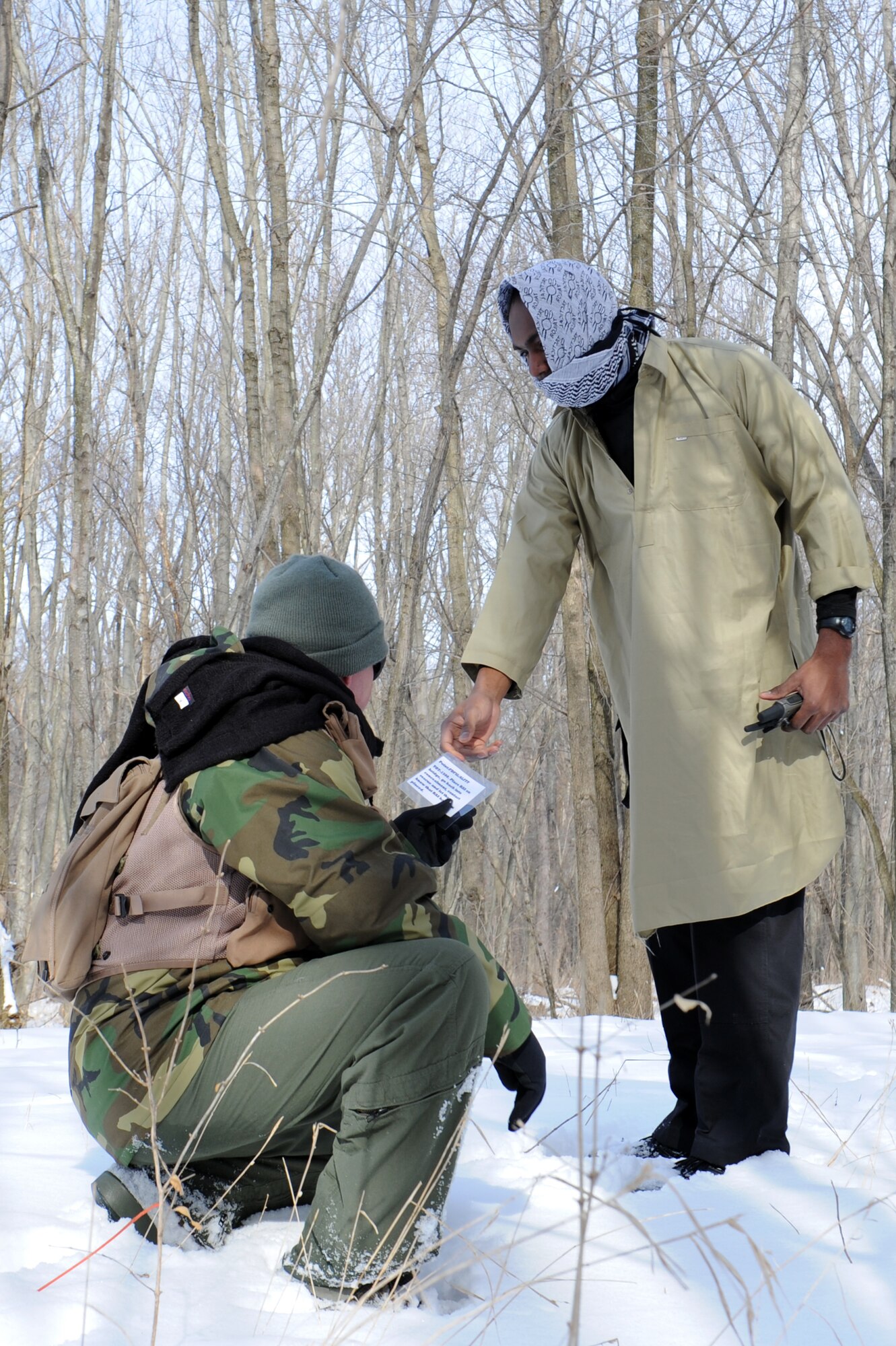 Master Sgt. Jamie Smith receives a clue from a simulated friendly local. Throughout the day, clues were given to Airmen that guided them between the various rally points in the area. (U.S. Air Force photo/Airman 1st Class Megan Friedl)