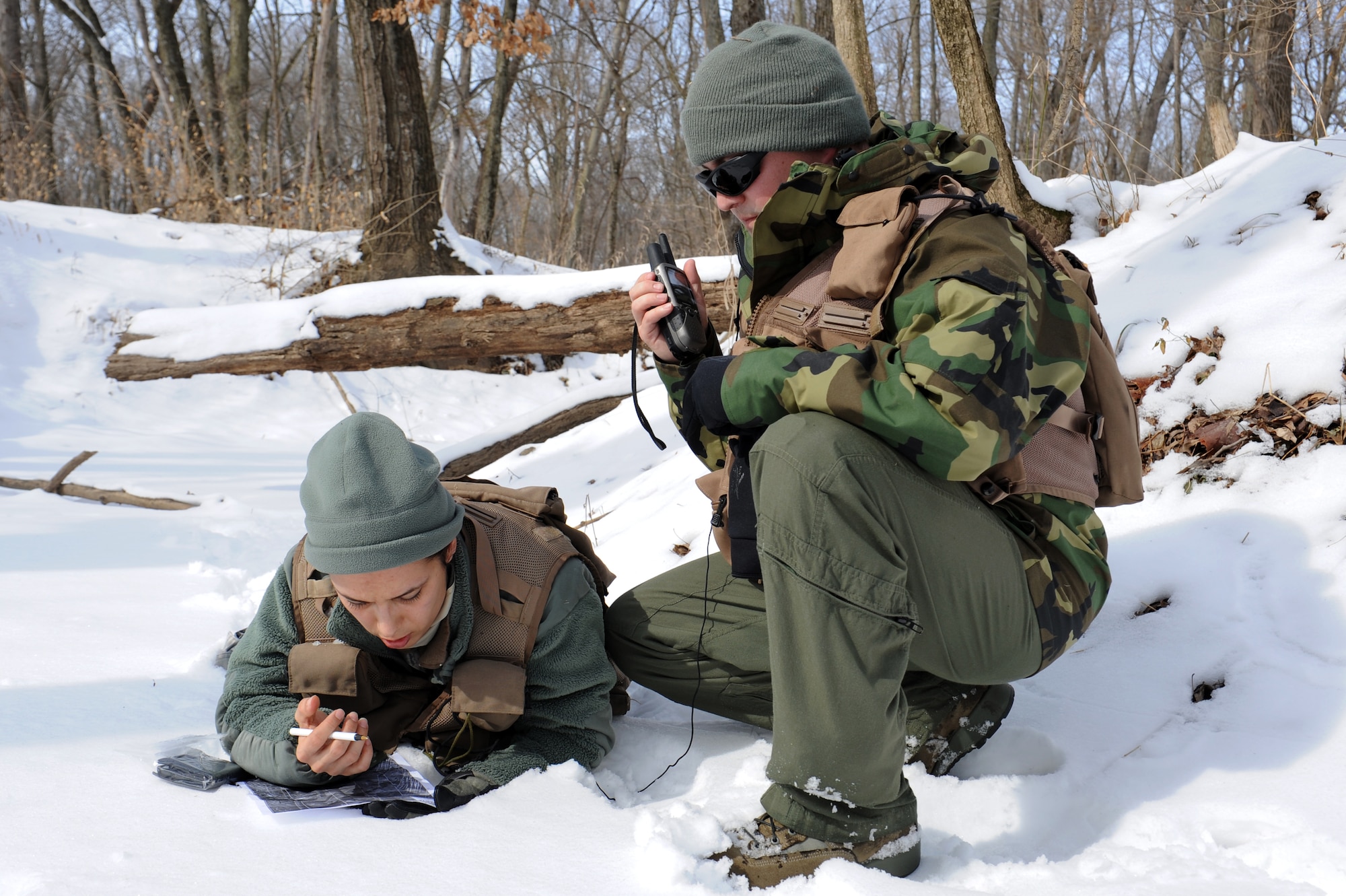 Master Sgt. Jamie Smith and Staff Sgt. Angel Zaragoza map out their next rally point during a Survival, Evasion, Resistance and Escape (SERE) course at the Illinois Army National Guard’s Training Area in Sparta, Ill. Feb. 12, 2014. Airmen learned navigation skills and how to use a map properly. Smith is with Air Mobility Command headquarters and Zaragoza is with the 375th Aeromedical Evacuation Squadron. (U.S. Air Force photo/Airman 1st Class Megan Friedl)